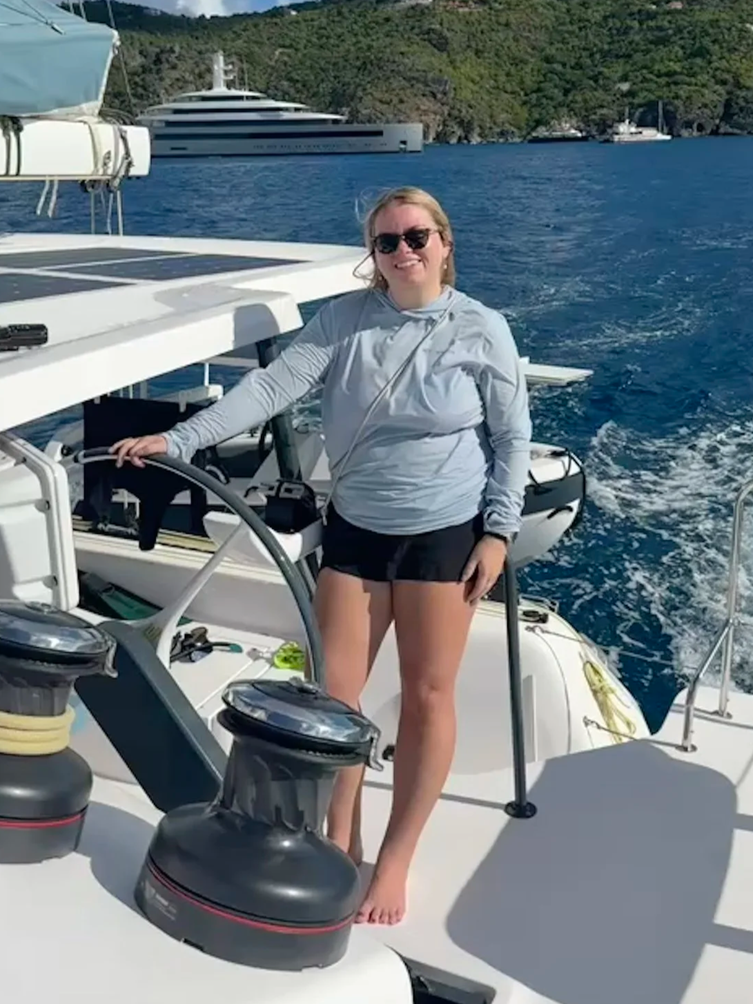 Hailey at the helm of a sailing yacht
