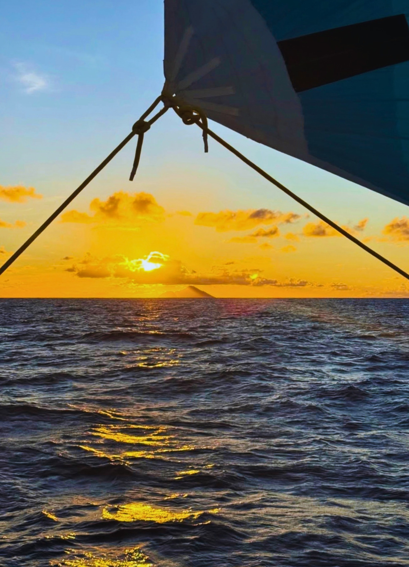 Sunset over the ocean from a sailing yacht