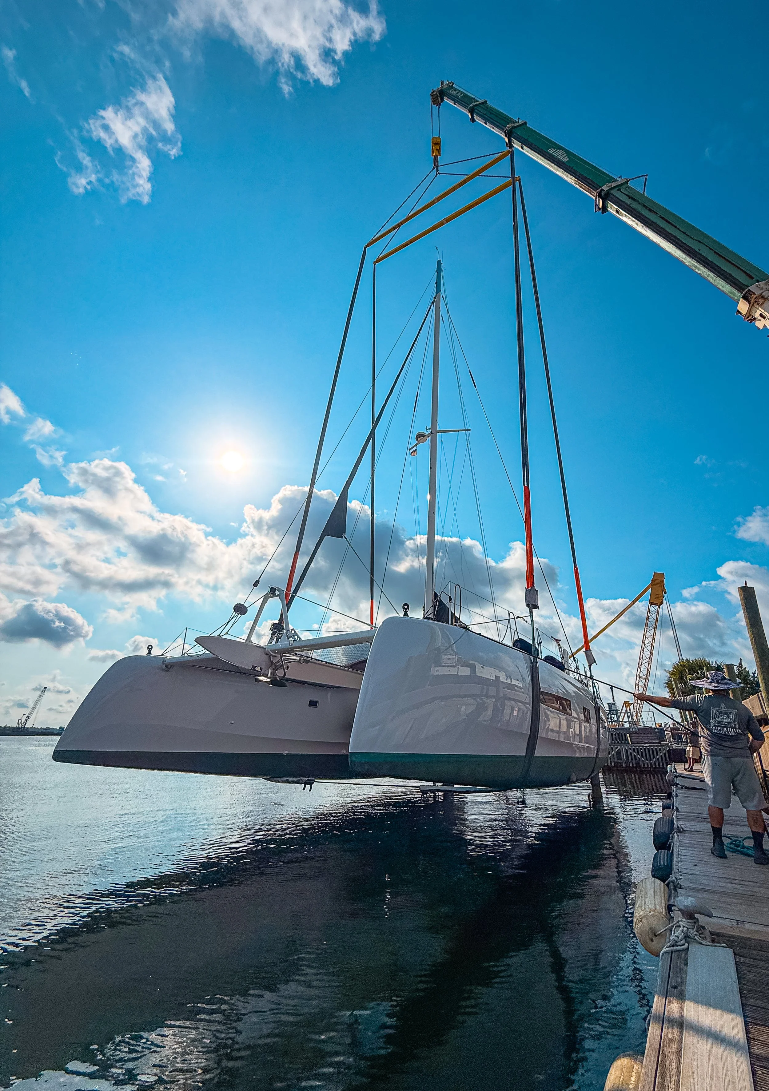 Yacht being launched by crane during a yard period