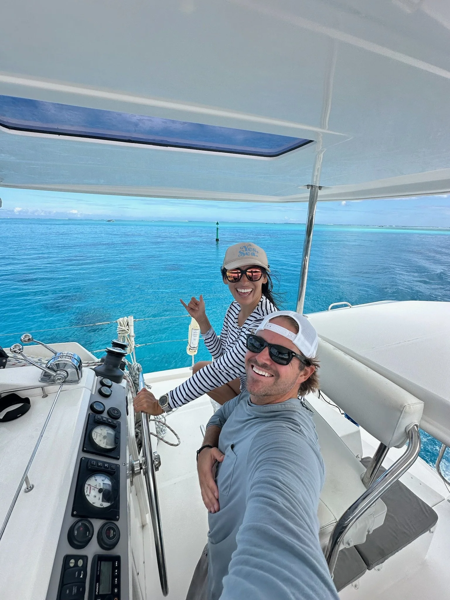 Nick and Brittney sailing a cruising catamaran in French Polynesia