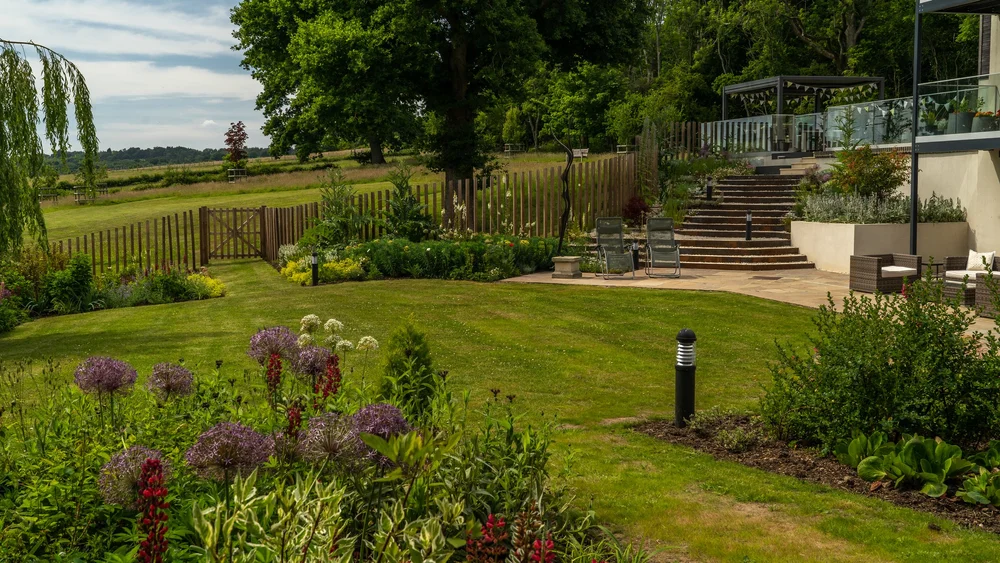 Explore The Paddocks: planted terraces and broad steps connect the house to the garden.