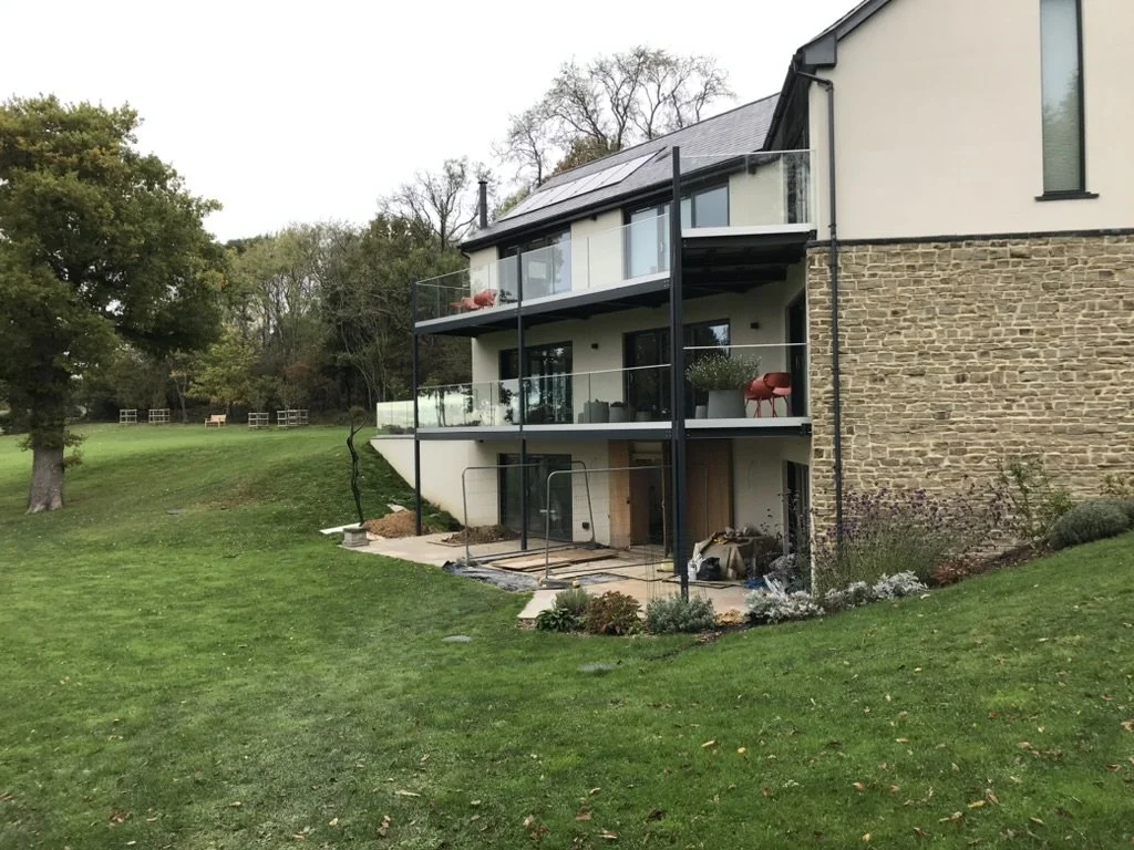 Before — a steep grass bank separated the living terrace from the lower garden.
