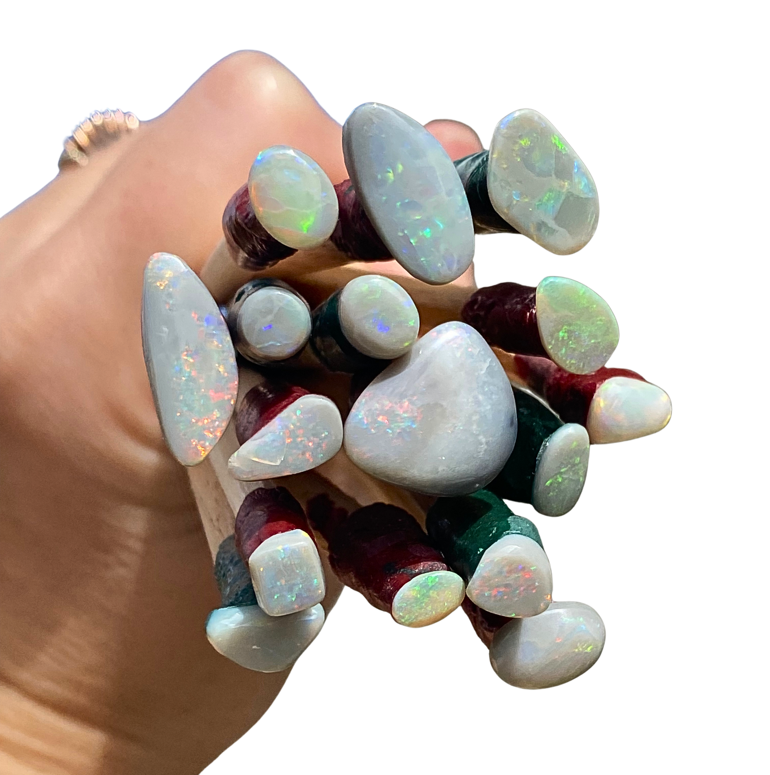 Opal bouquet, freshly polished opals, just after cutting still on dop sticks attached with wax.