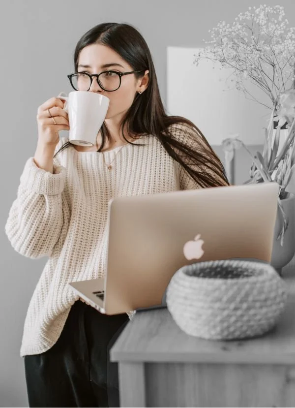 PLEB Group website integrations of a woman with a cup of copy and a laptop