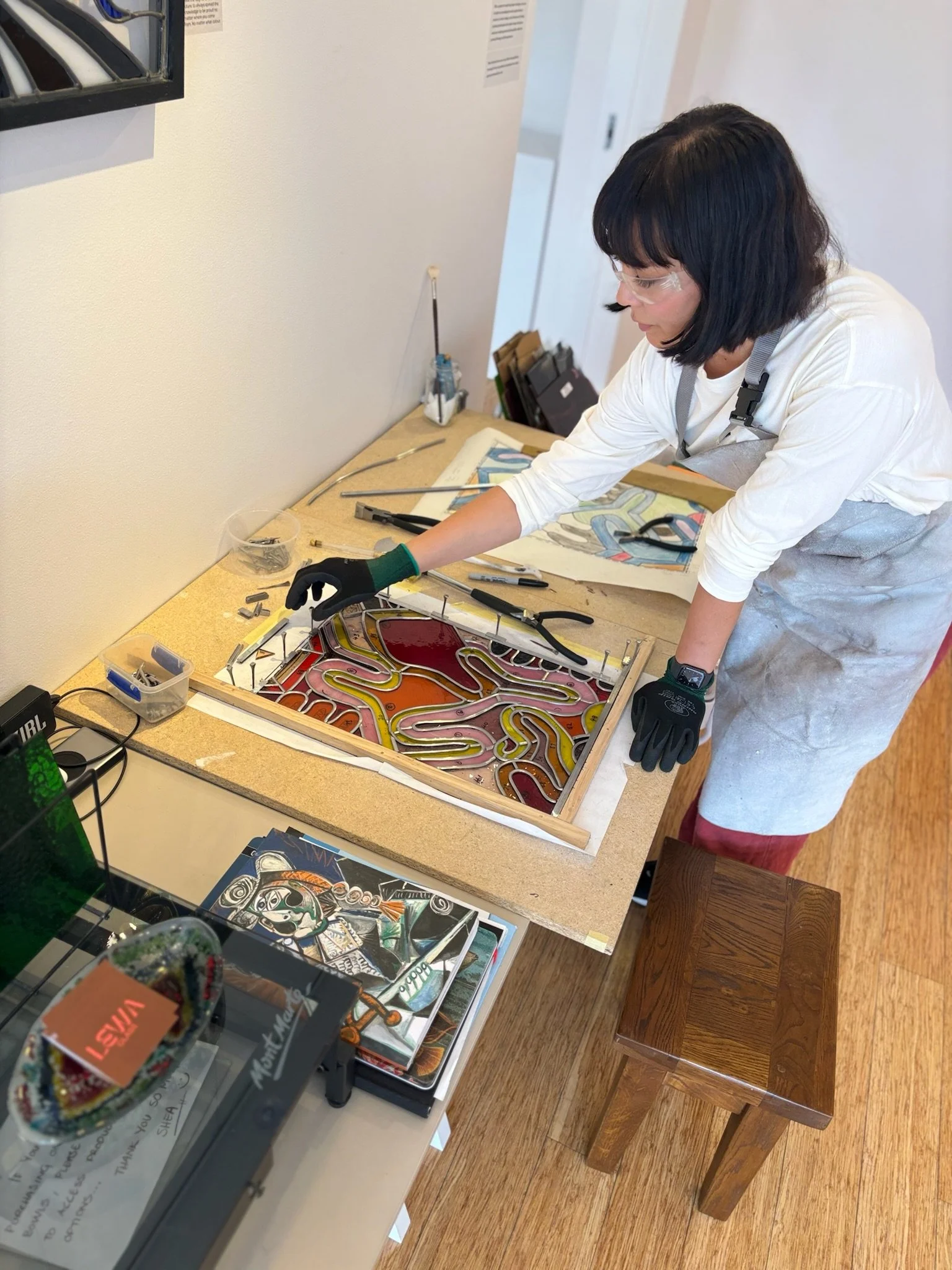 Working in the Gallery showing visitors how to construct a leadlight panel
