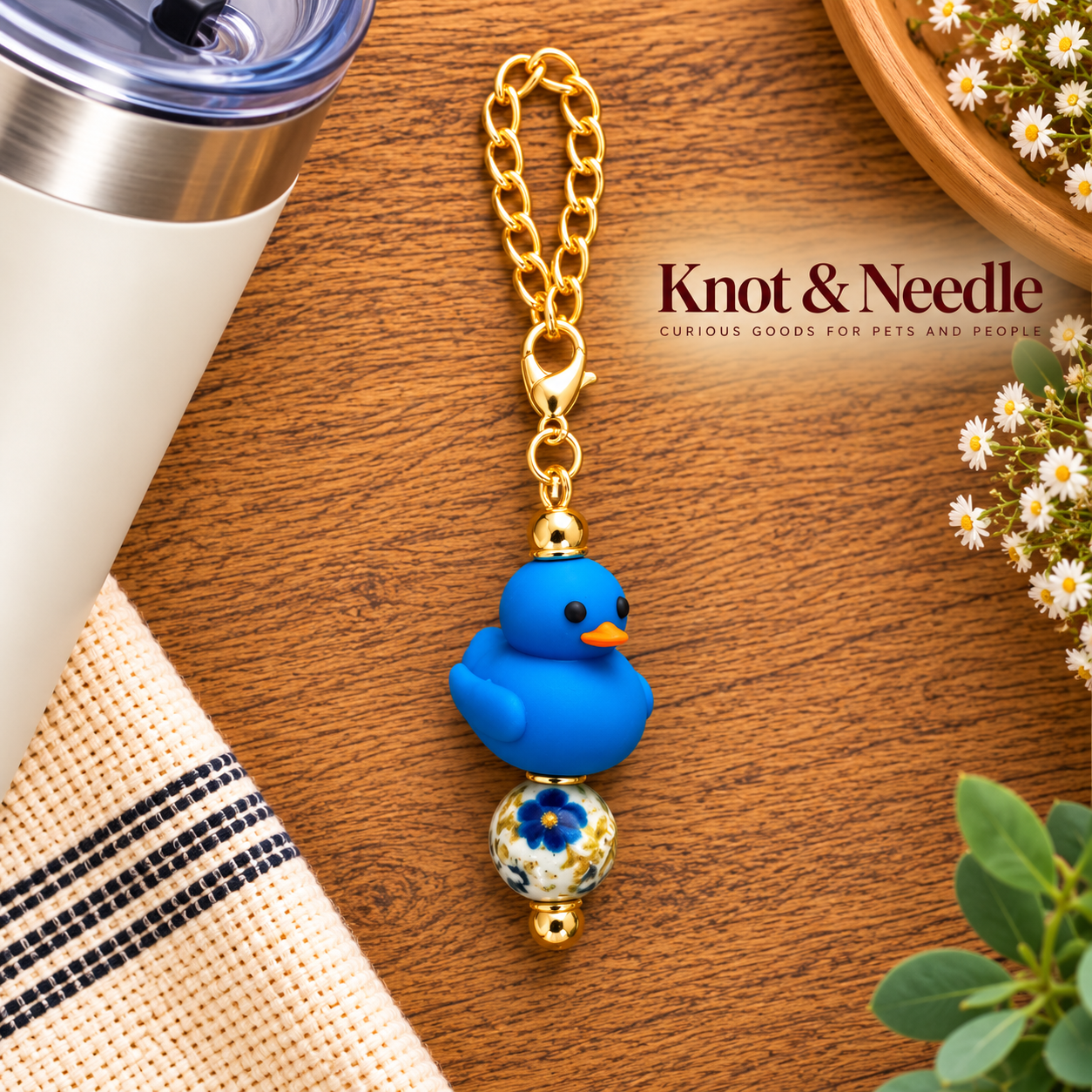 Blue Duck Charm on Wooden Flat Lay.png