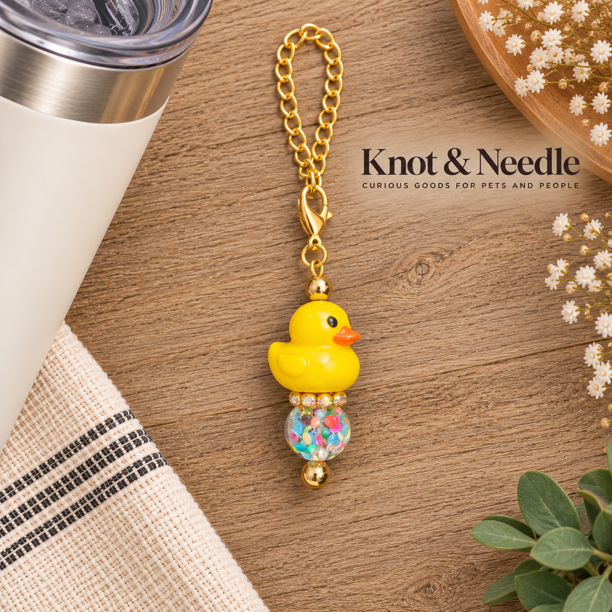 Golden Duck Charm Flat Lay.png