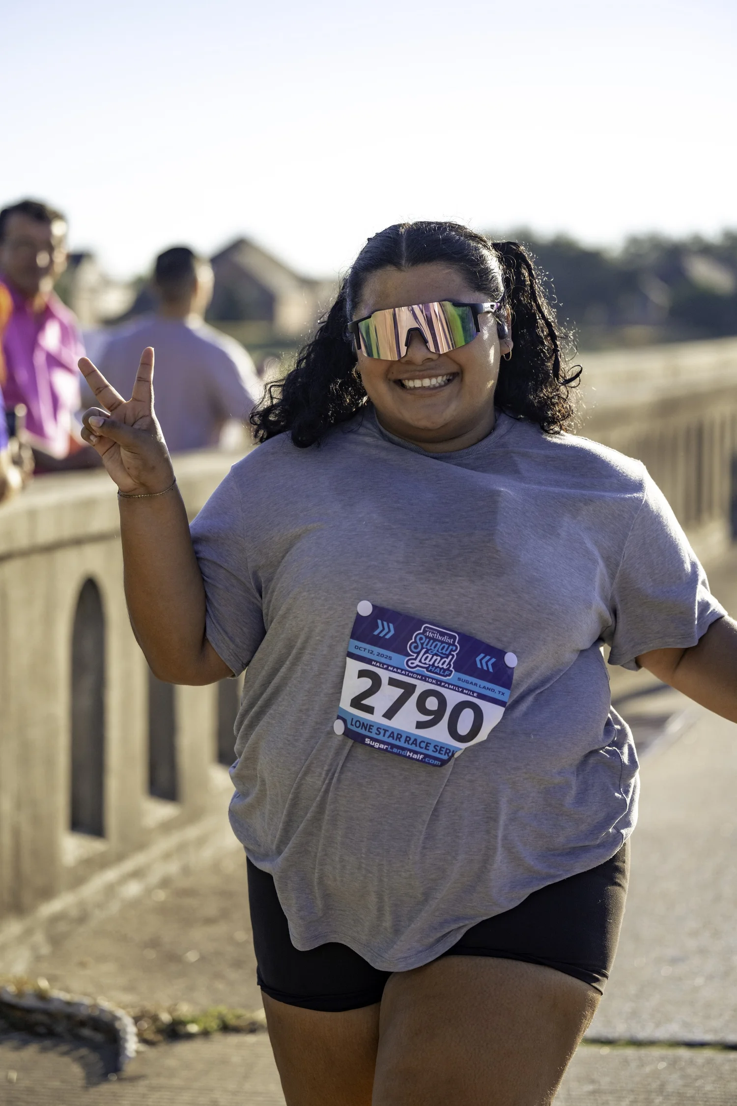 An adult Sugar Land participant smiling on race day