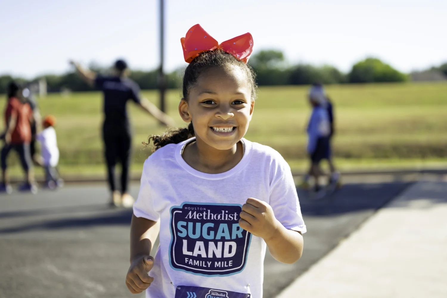 A young runner enjoying the Sugar Land family mile