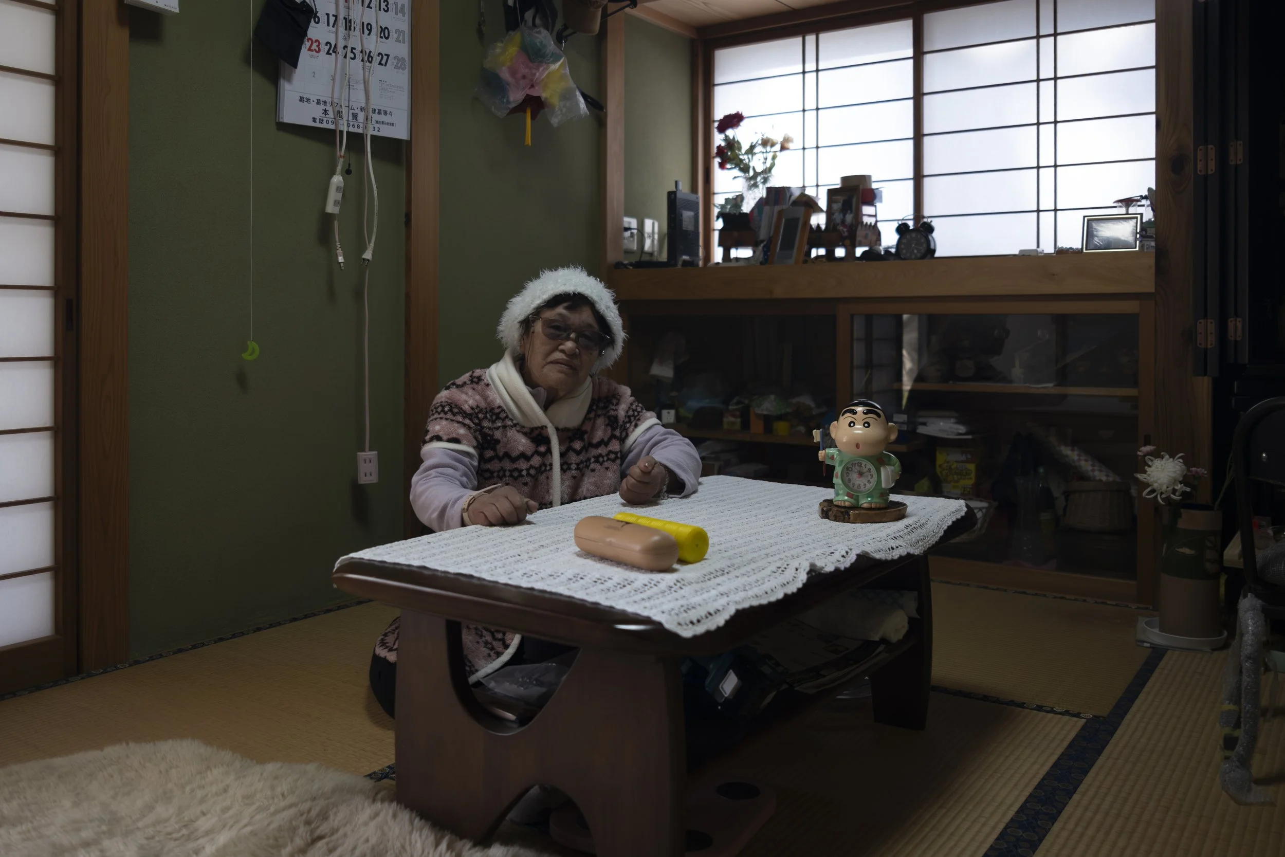 Yukiko Watanabe, elderly woman seated at a low table inside her home in Kinugawa Onsen.