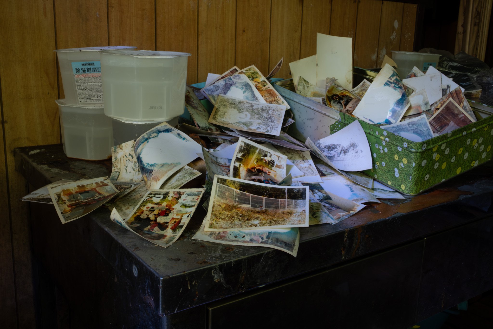 Found photographs scattered across a table inside an abandoned building in Kinugawa Onsen.