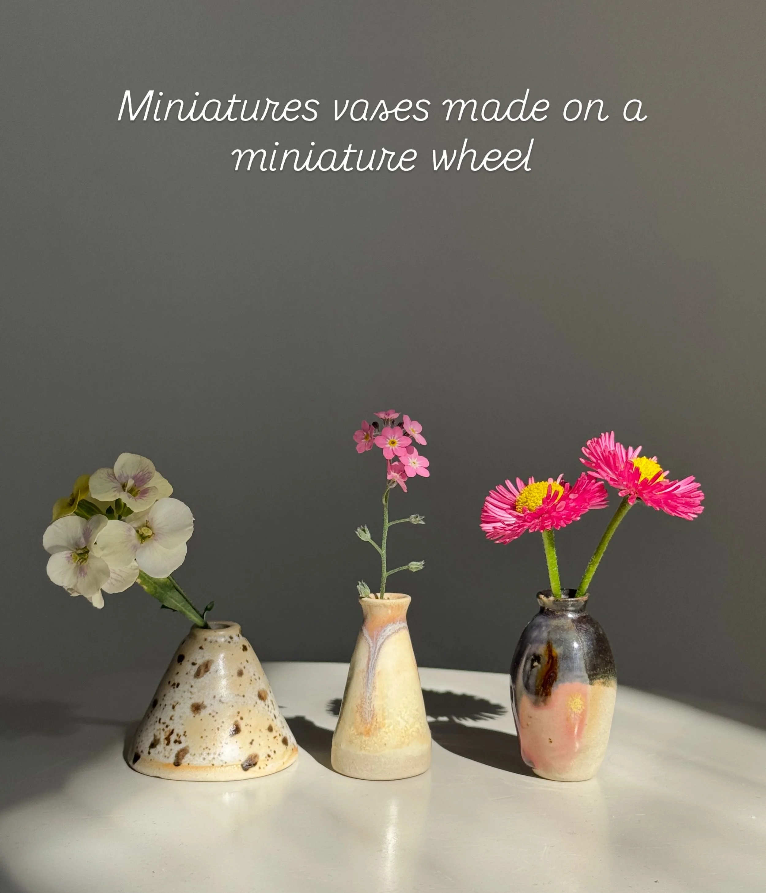 Teeny tiny vases I made on a tiny wheel.  Swipe for a visual size reference but these little pots are smaller than the height of a Burt&rsquo;s Bees chapstick. 

I threw these cuties on a $50 mini wheel I bought online.  I wanted to throw at home vs 
