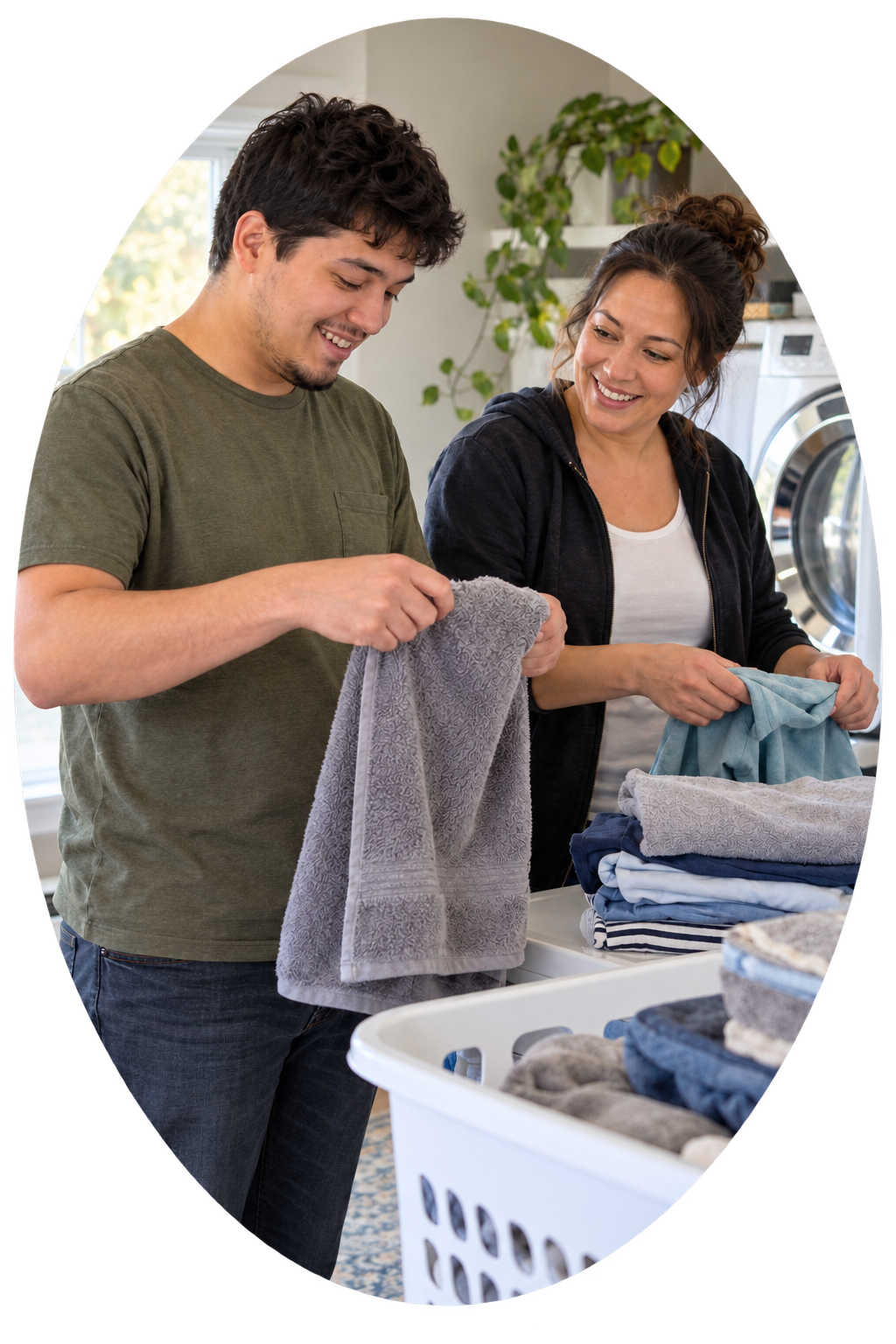 A man and woman folding laundry together in a laundry room.