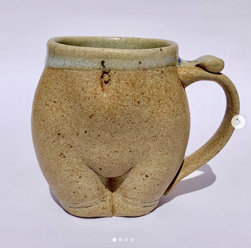 A ceramic mug designed to resemble a human body with the handle. Food and dishwasher safe. 