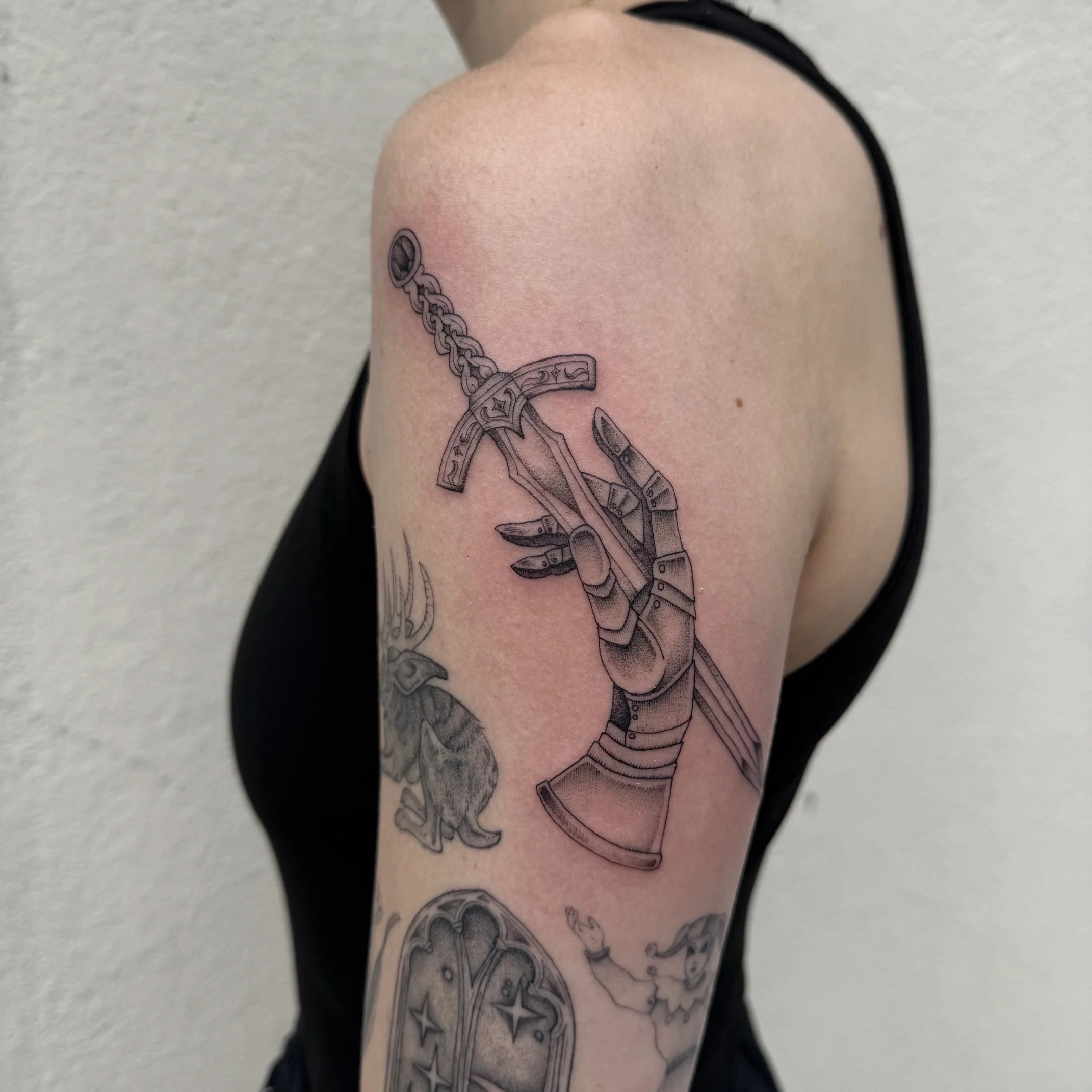 Knight Hand and Sword Tattoo by Madison Paige Davenport at Handsome Devil Tattoo Company in Saddle Brook, New Jersey.
