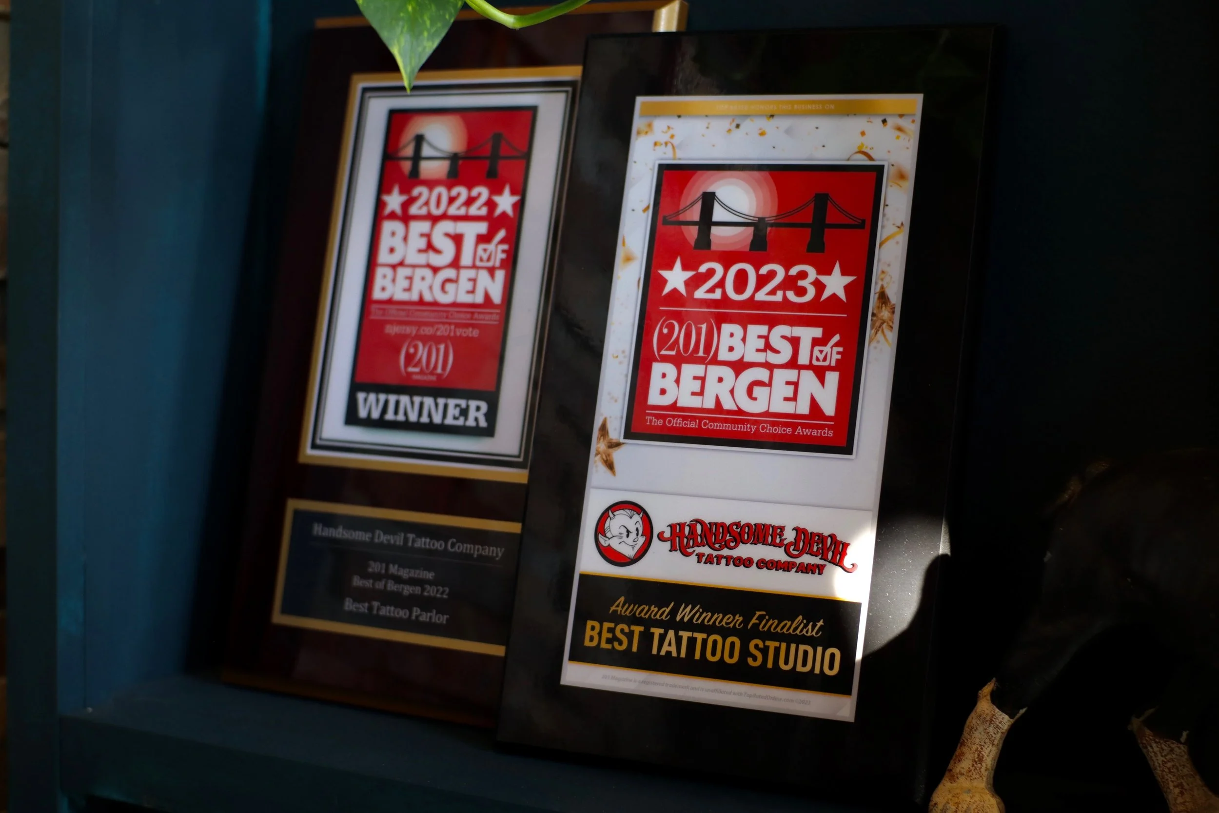 Vintage decor and Handsome Devil Tattoo Company sign displayed inside the tattoo studio in Saddle Brook, New Jersey.