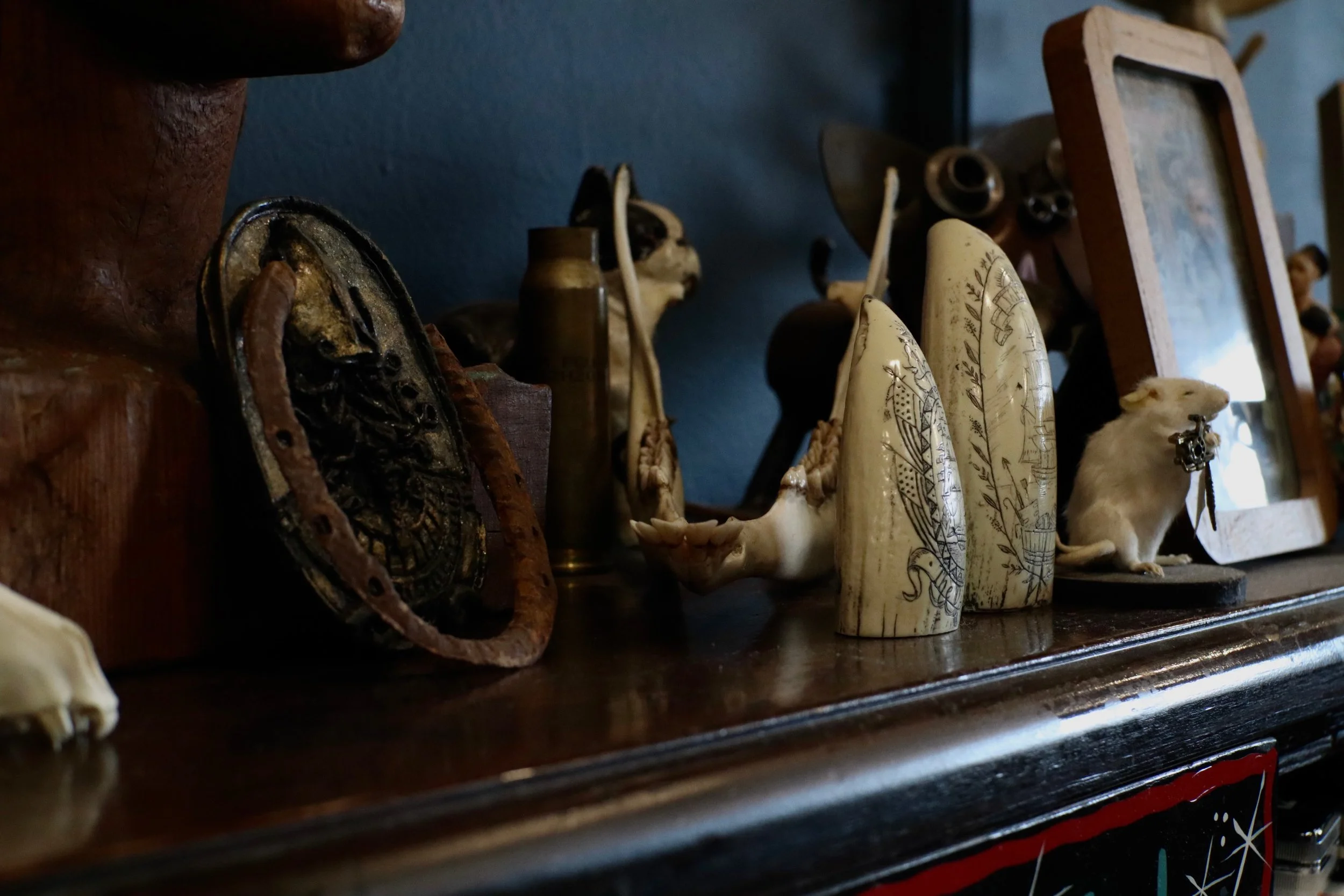 Vintage decor and Handsome Devil Tattoo Company sign displayed inside the tattoo studio in Saddle Brook, New Jersey.