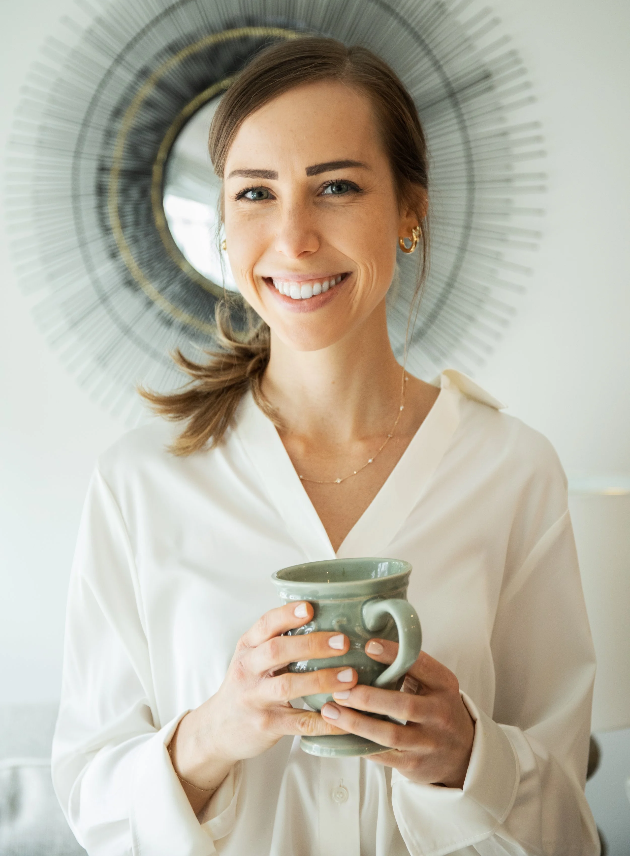 Ashley Tweddle smiling and holding a mug