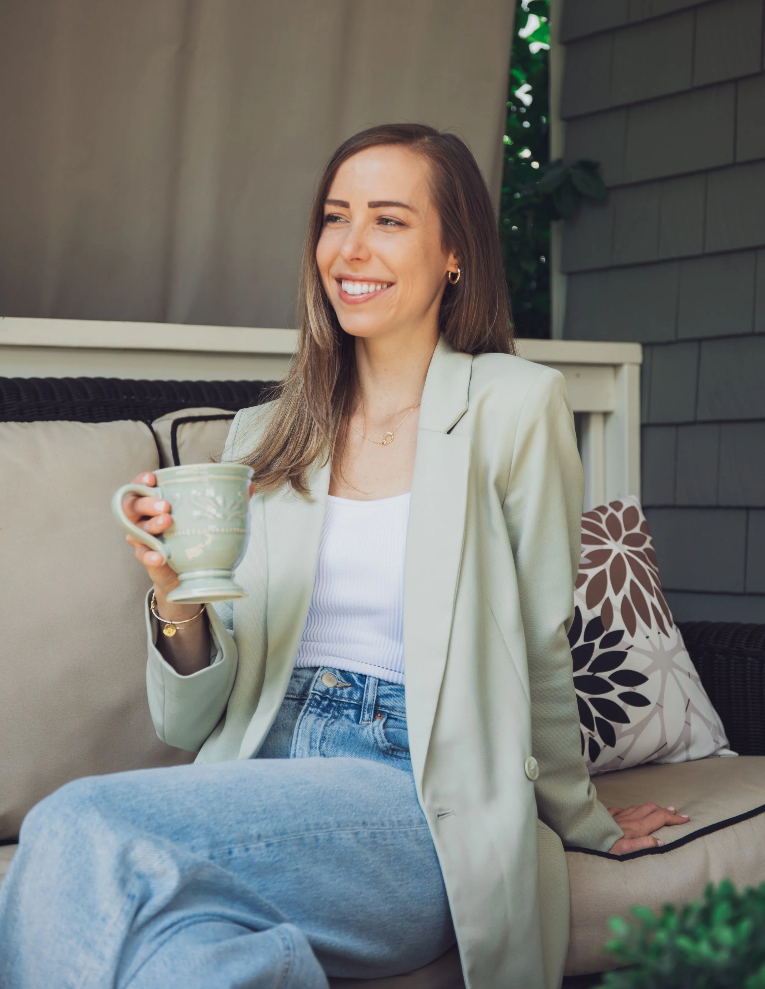 Ashley Tweddle sitting outdoors with a mug.