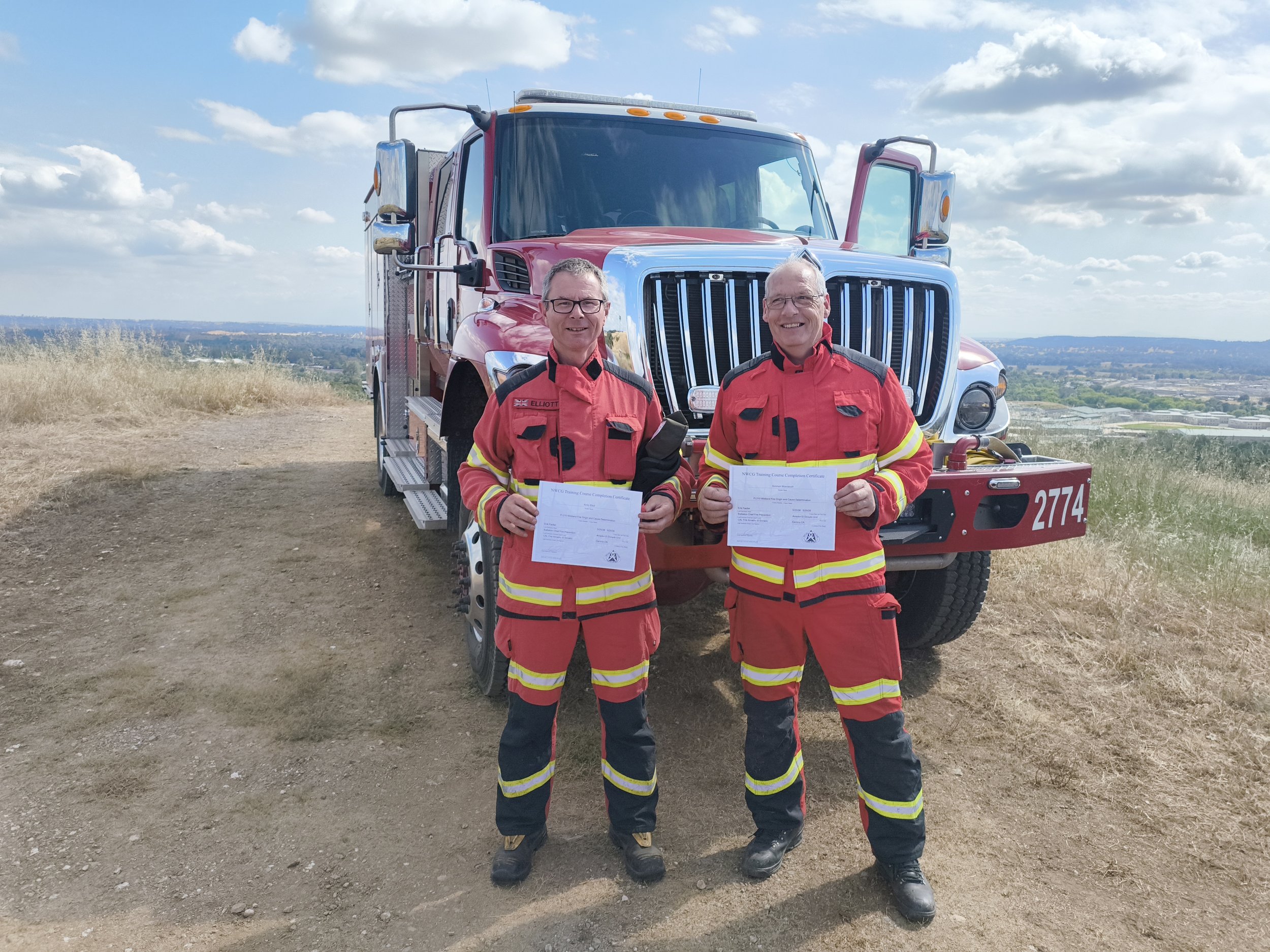 Andy and Simon as wildland fire investigators in front of a wildfire fire engine in California.