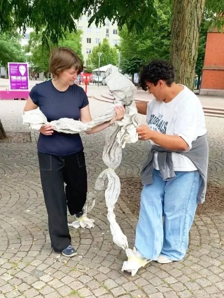 Laura Geiger and participant animating a life-size paper puppet in Helsingborg Sweden