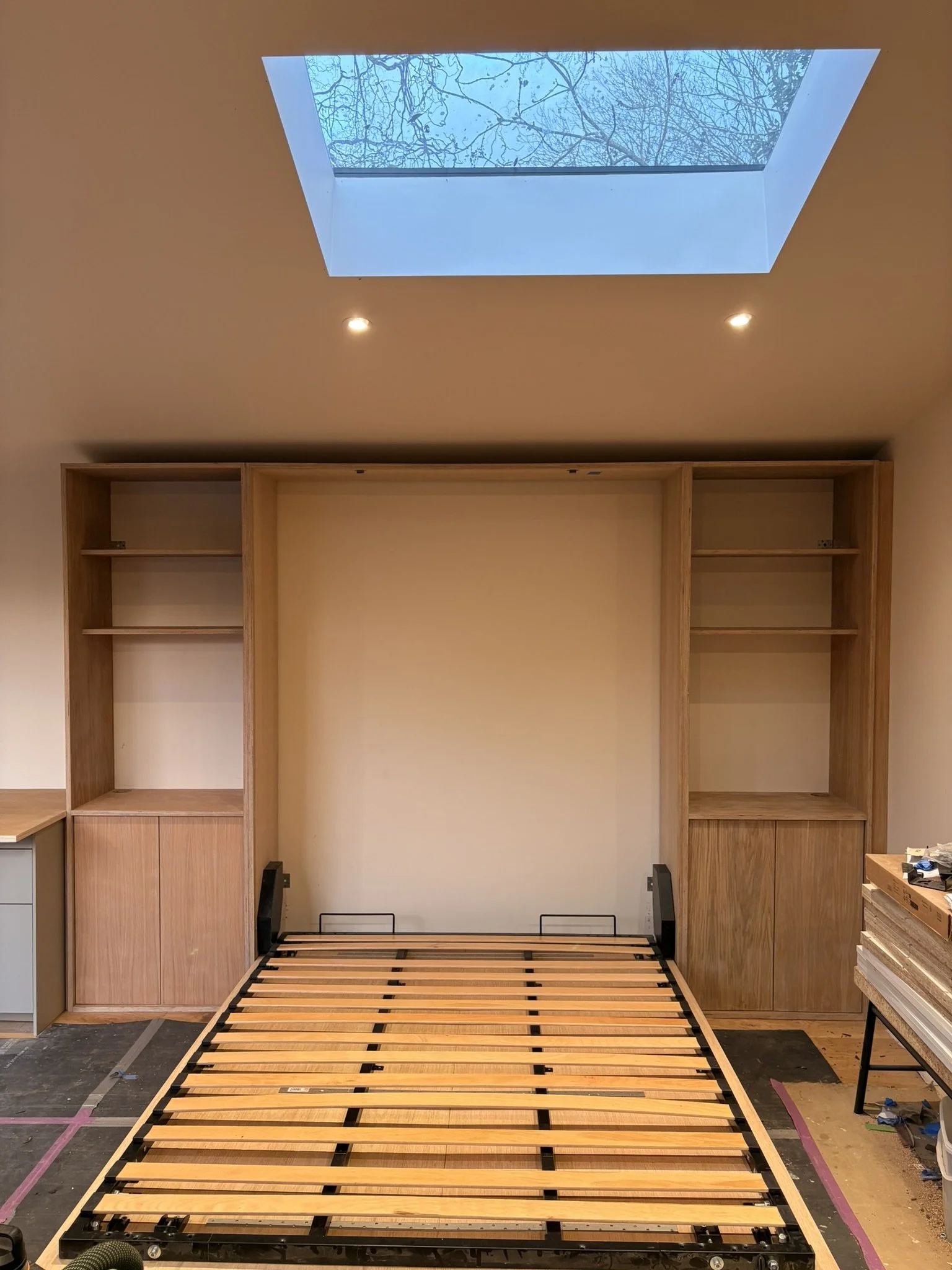 Bespoke oak veneer ply folding bed & storage units.