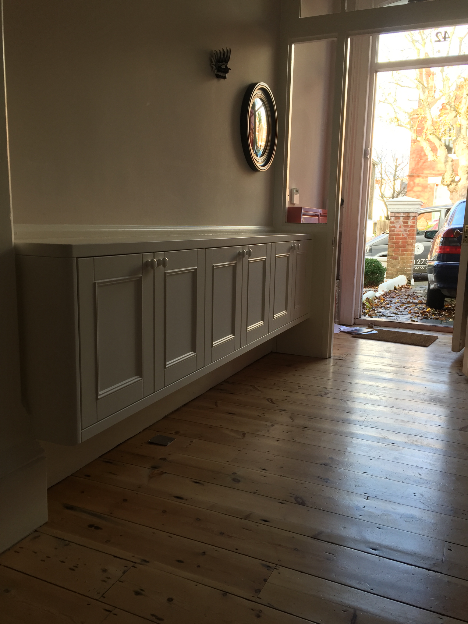 Entrance storage unit with shaker style doors and ogee detail.