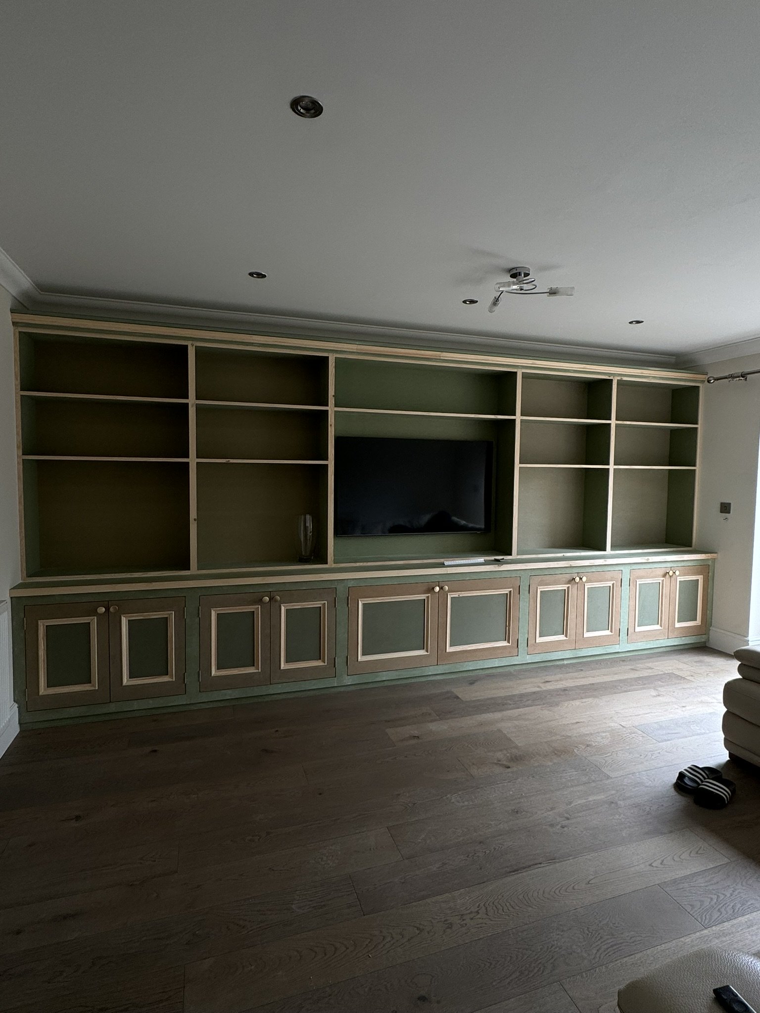 Custom media wall and storage with shelving.