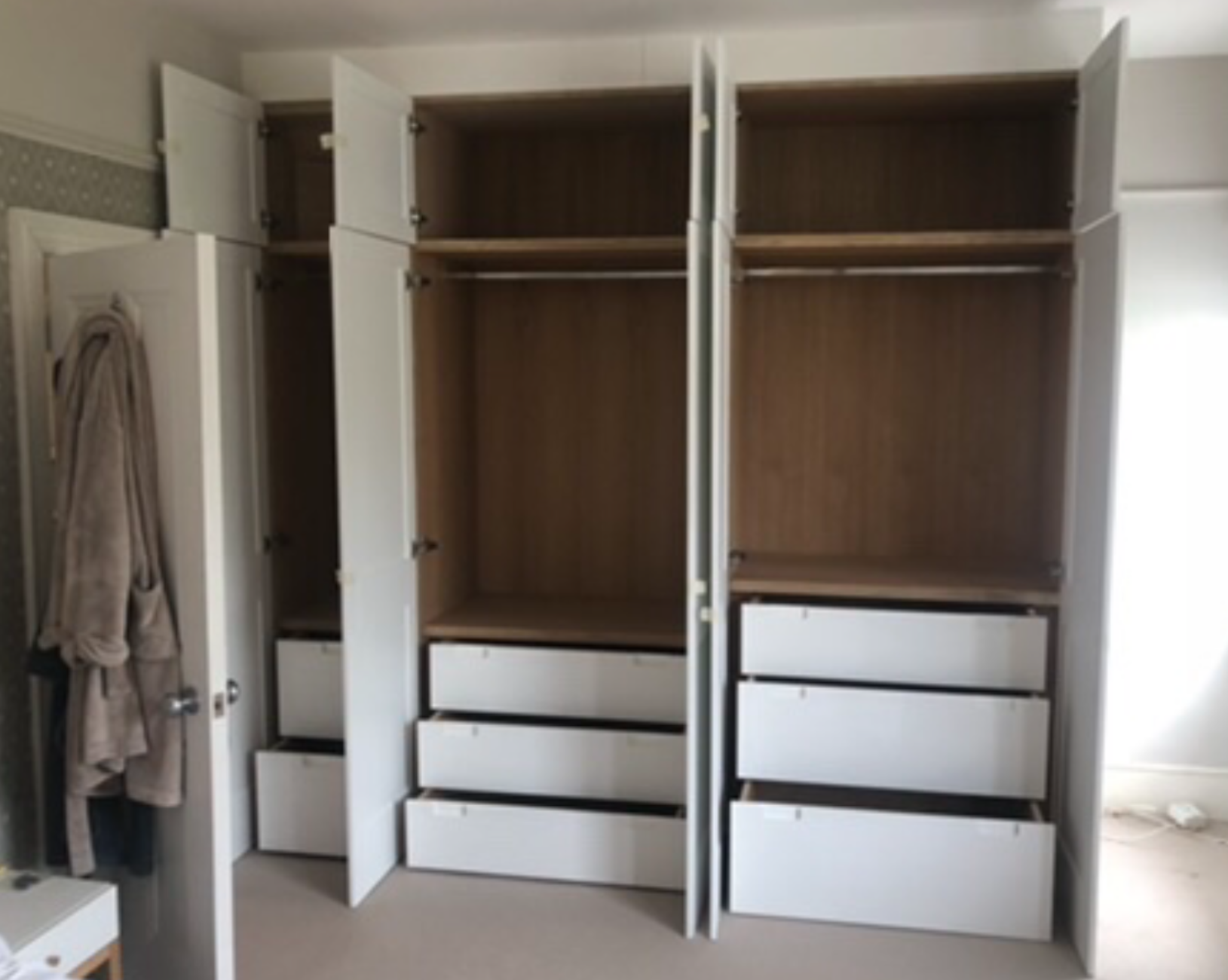 Oak veneer internal carcass and drawers for built-in wardrobes.