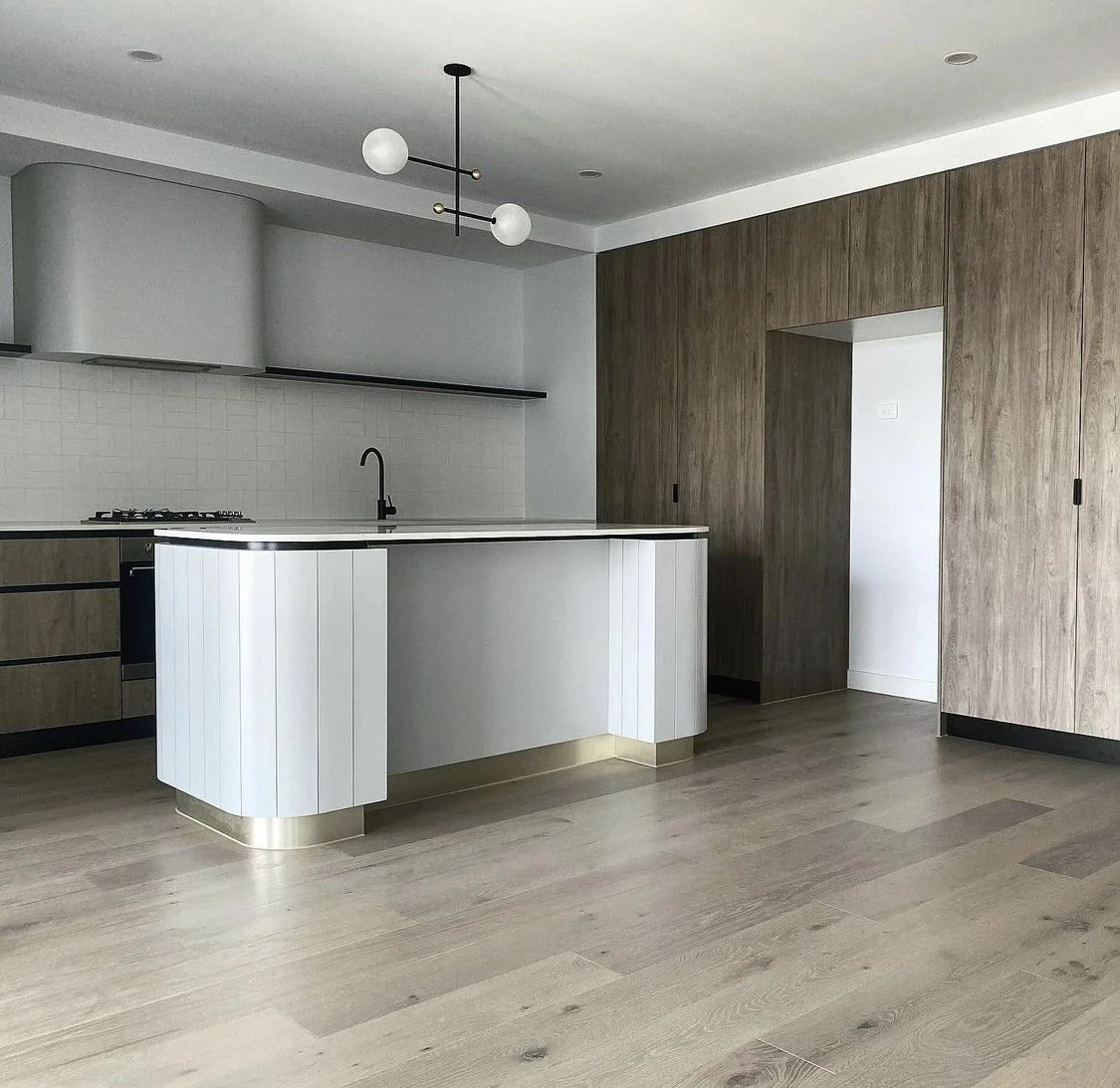 Custom modern kitchen with bespoke fitted units and curved island.