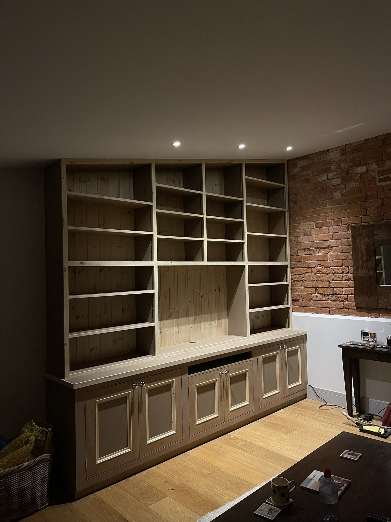 Media wall with adjustable shelving. 