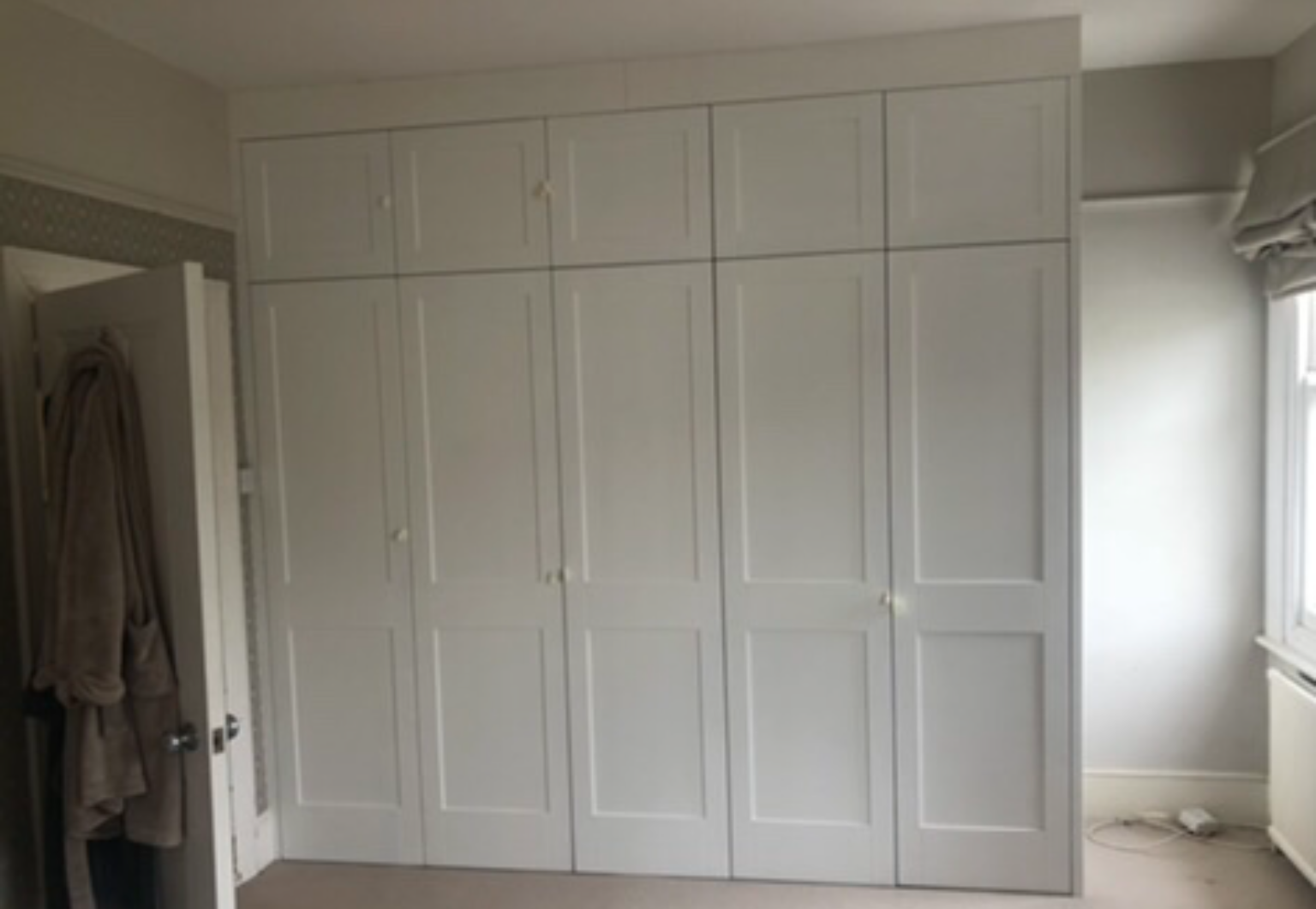 Sprayed finish white shaker doors for built in wardrobe.