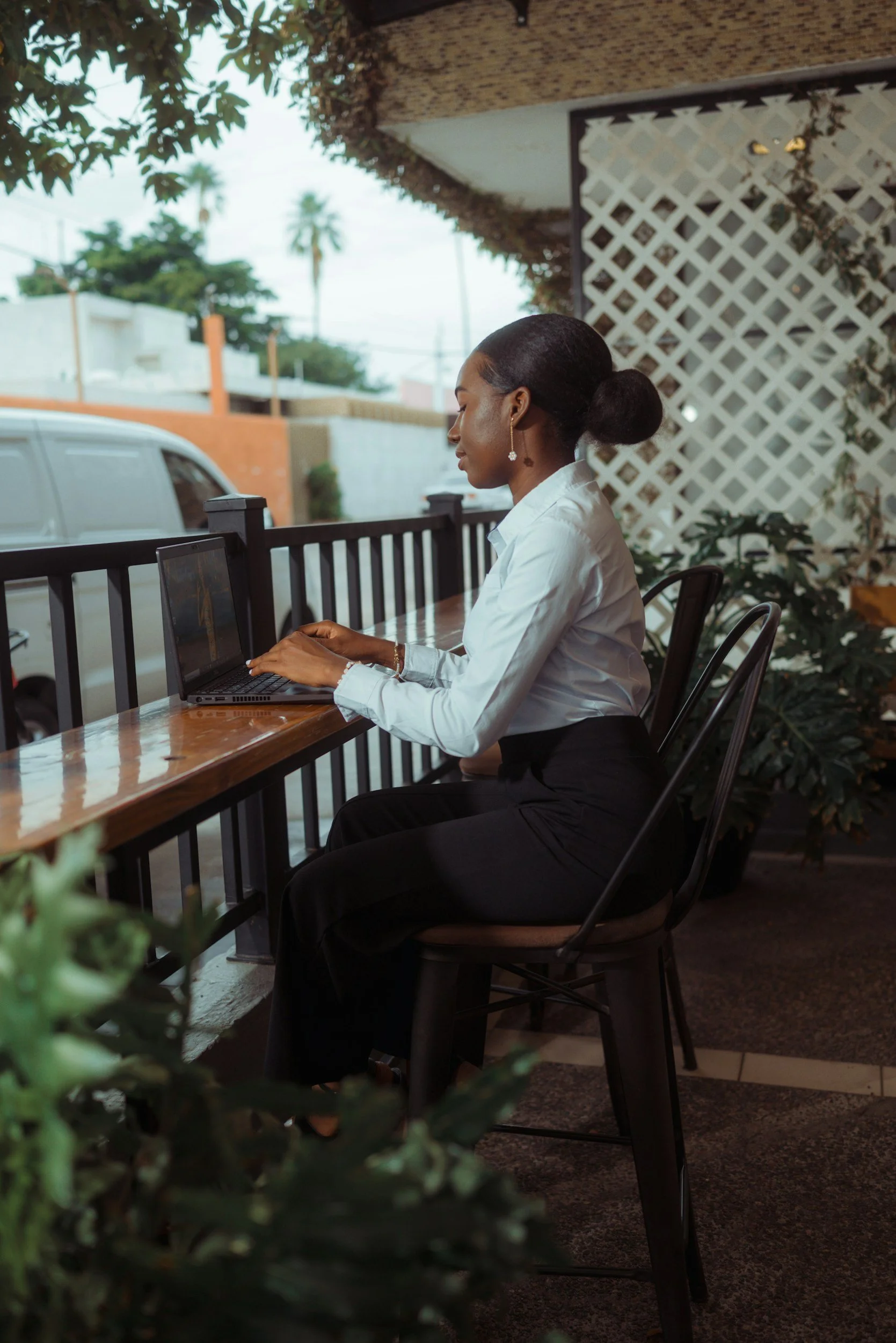 Small business owner working on a laptop at an outdoor desk
