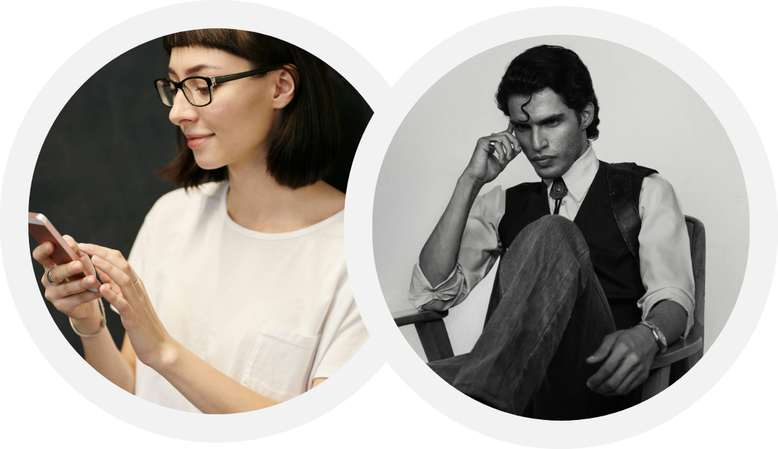 Side profile of a woman wearing glasses and a white t-shirt, looking at her phone, and a man with curly hair sitting on a chair, wearing a dress shirt with rolled-up sleeves and a vest, with a serious expression.