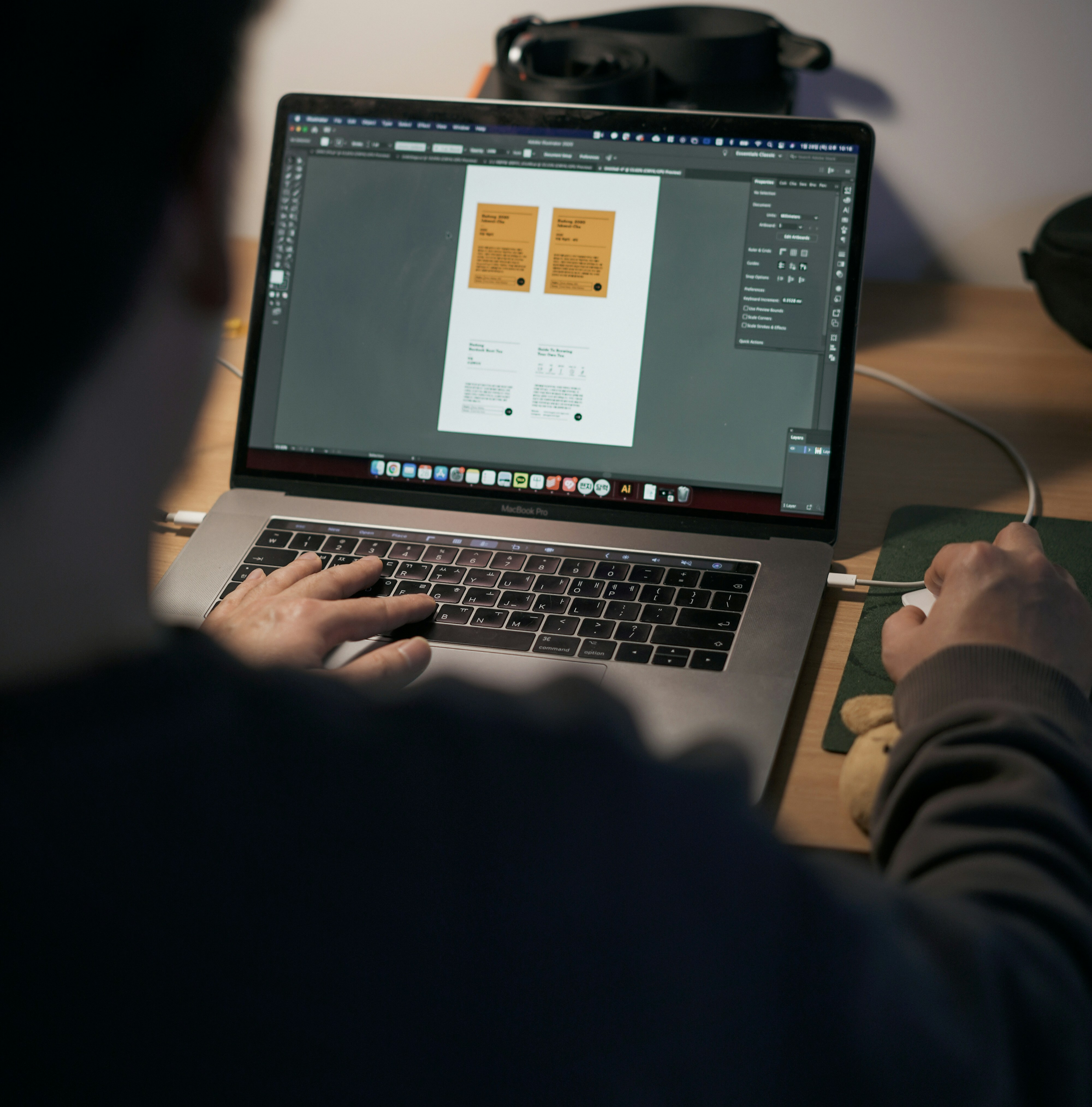 A person typing on a laptop keyboard with two recipe cards on the screen and a black bag in the background.