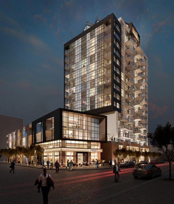 A modern high-rise building with glass windows and balconies, illuminated at night, with people walking on the street in front of it.