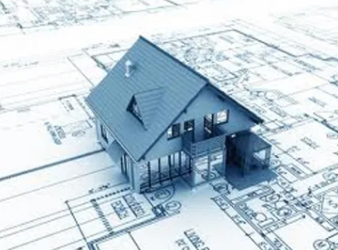 Wicked Maple Design - A model of a house on top of architectural blueprints.