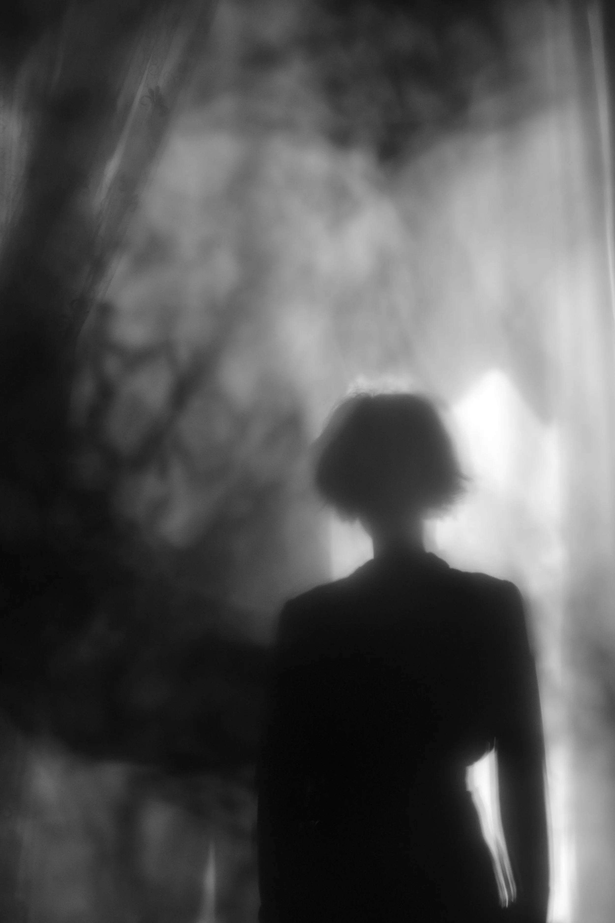 Blurred silhouette of a person in soft light, representing how trauma can show up in daily life
