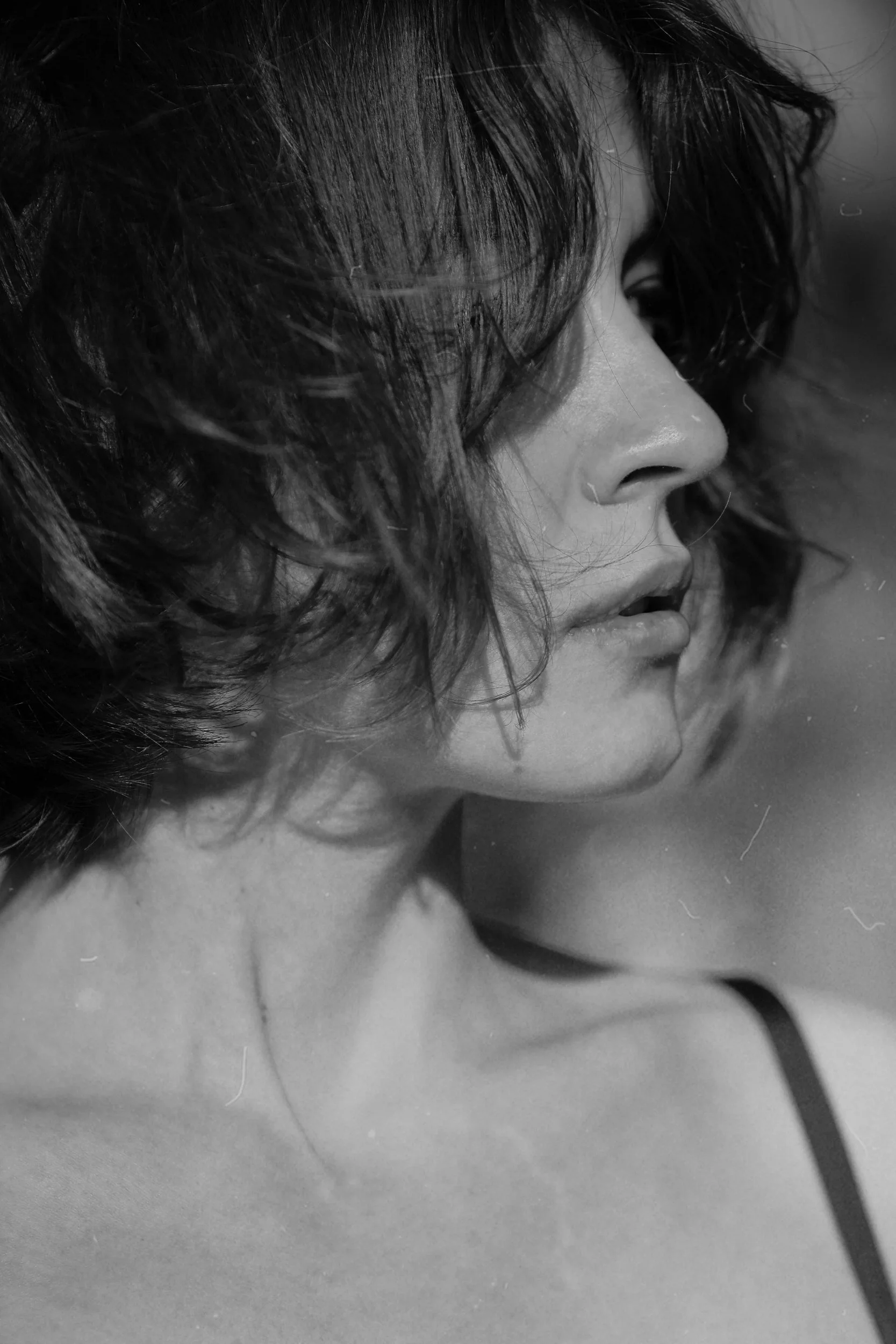Black-and-white portrait of a woman looking to the side, reflecting the inner work of IFS therapy