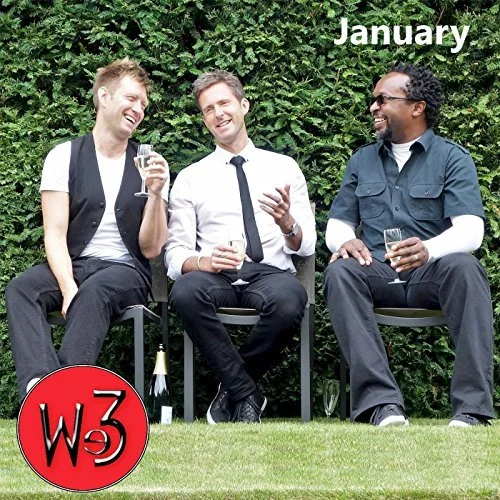 Three men sitting outside on chairs, holding glasses, laughing and talking, with greenery in the background. The word "January" is in the top right corner, and a red circle with "We3" is in the bottom left corner.