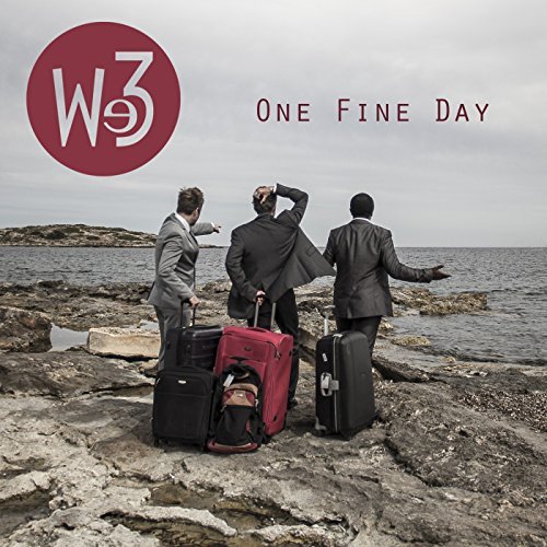 Three men in suits with luggage standing on a rocky shoreline looking out at the ocean, with the words "One Fine Day" and a logo with "We3" in the top left corner.