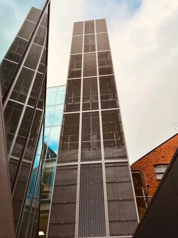 Full-height view of the mesh-clad steel fire escape within the courtyard at Blagrave Street, Reading.