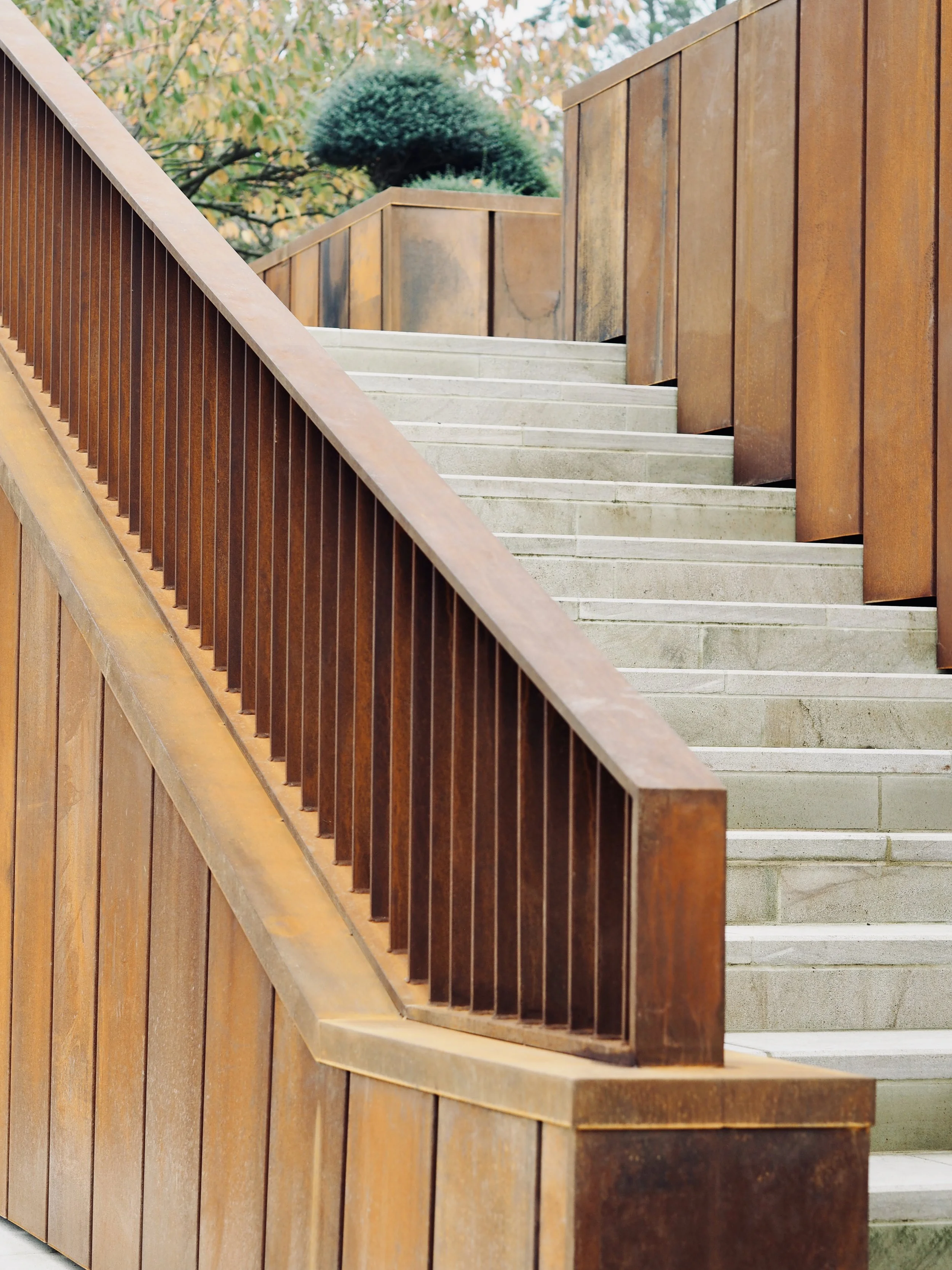 Corten steel balustrades and folded cladding framing the external staircase at Rotherfield.