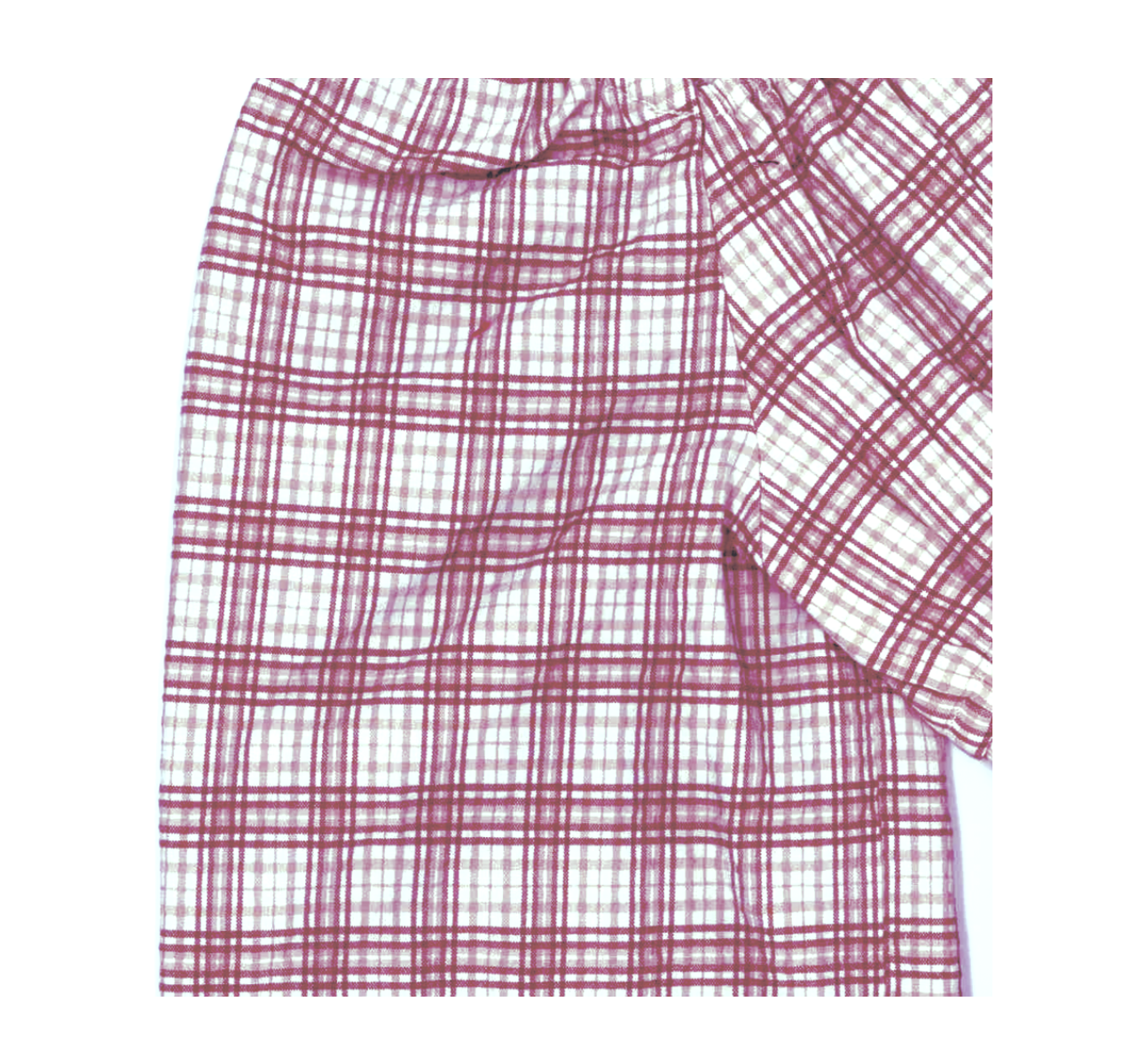A piece of cloth with a red and white plaid pattern, showing multiple layers and folds.