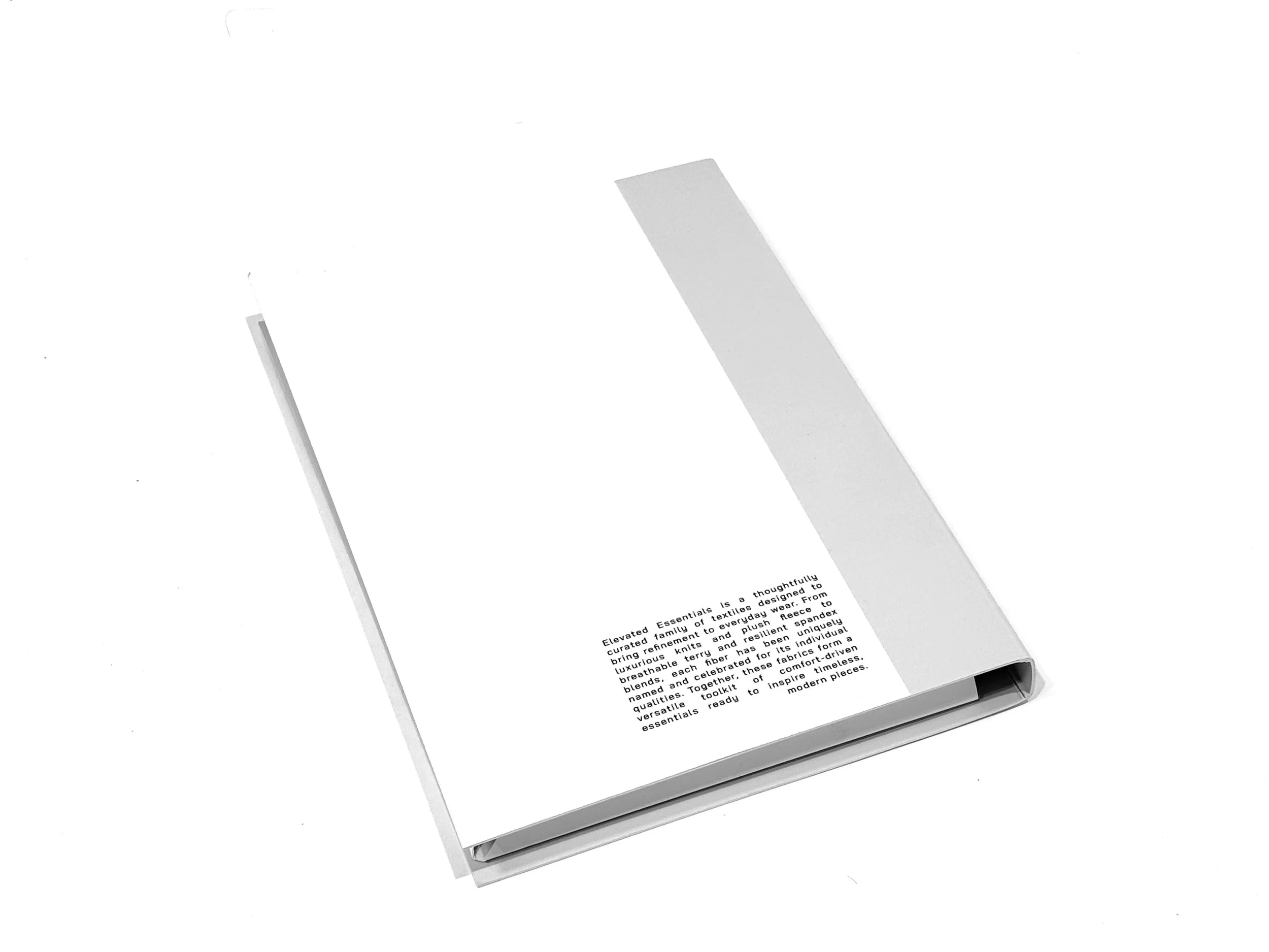 A folded paper brochure with text describing textiles and fabrics on a white background.