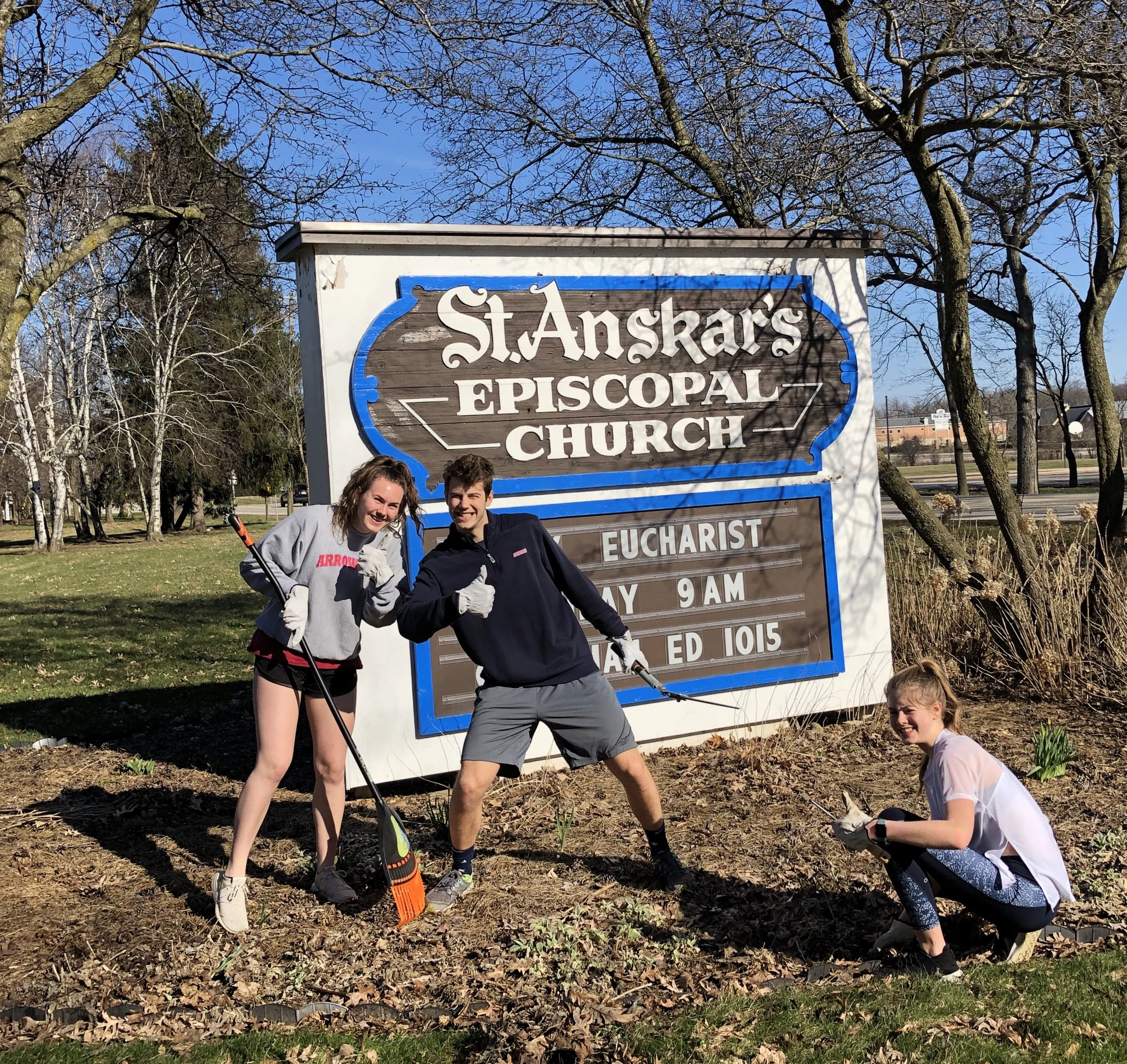 Parishioners plant flowers around the St. Anskar’s Episcopal Church sign along Highway 83 in Hartland, Wisconsin.