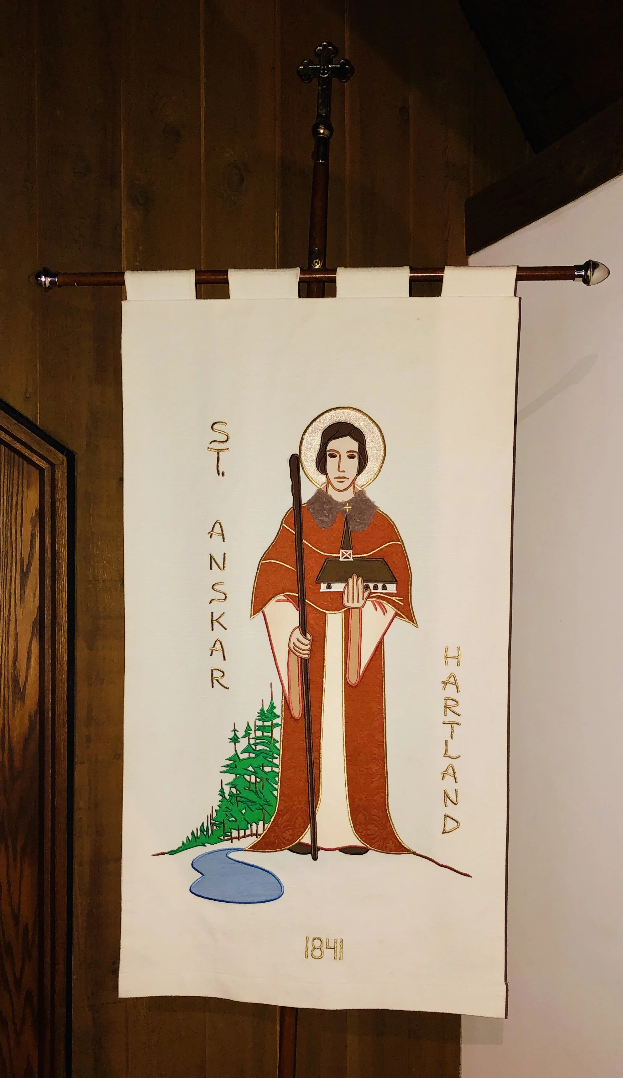 Banner depicting St. Anskar holding a pastoral staff, the patron saint for whom St. Anskar’s Episcopal Church is named.