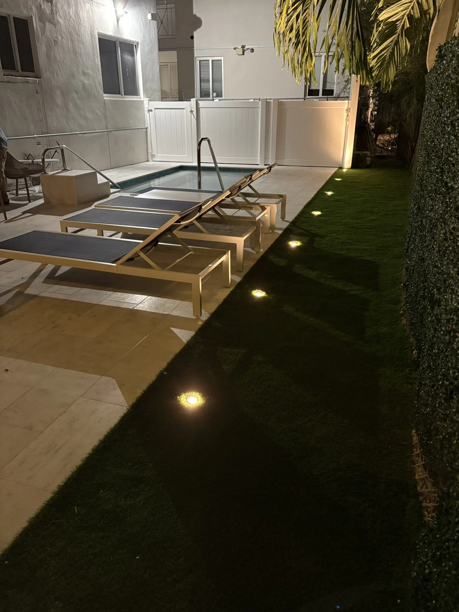 Finished landscape lighting highlighting the property at night.