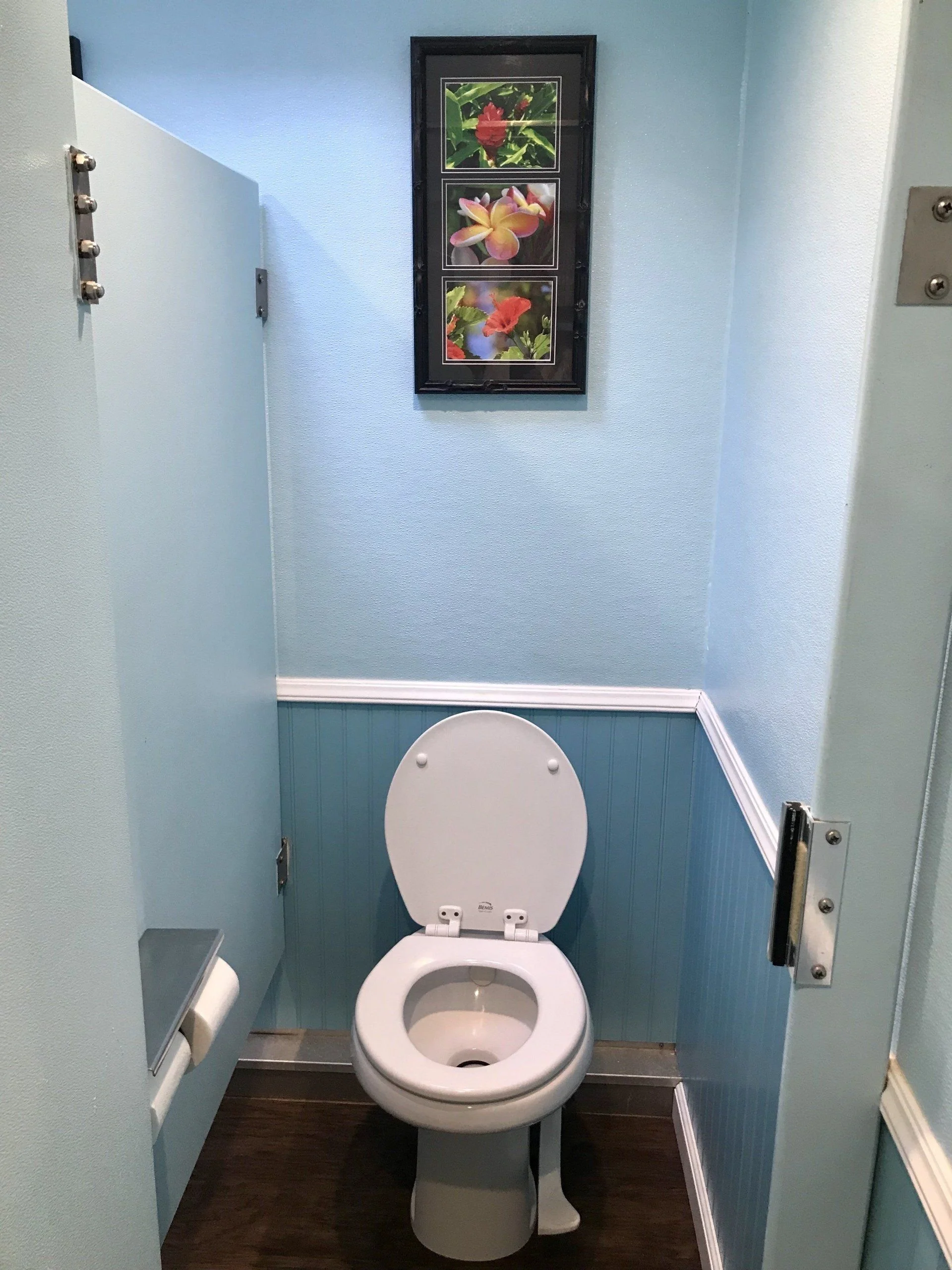 Toilet stall inside an event restroom trailer.