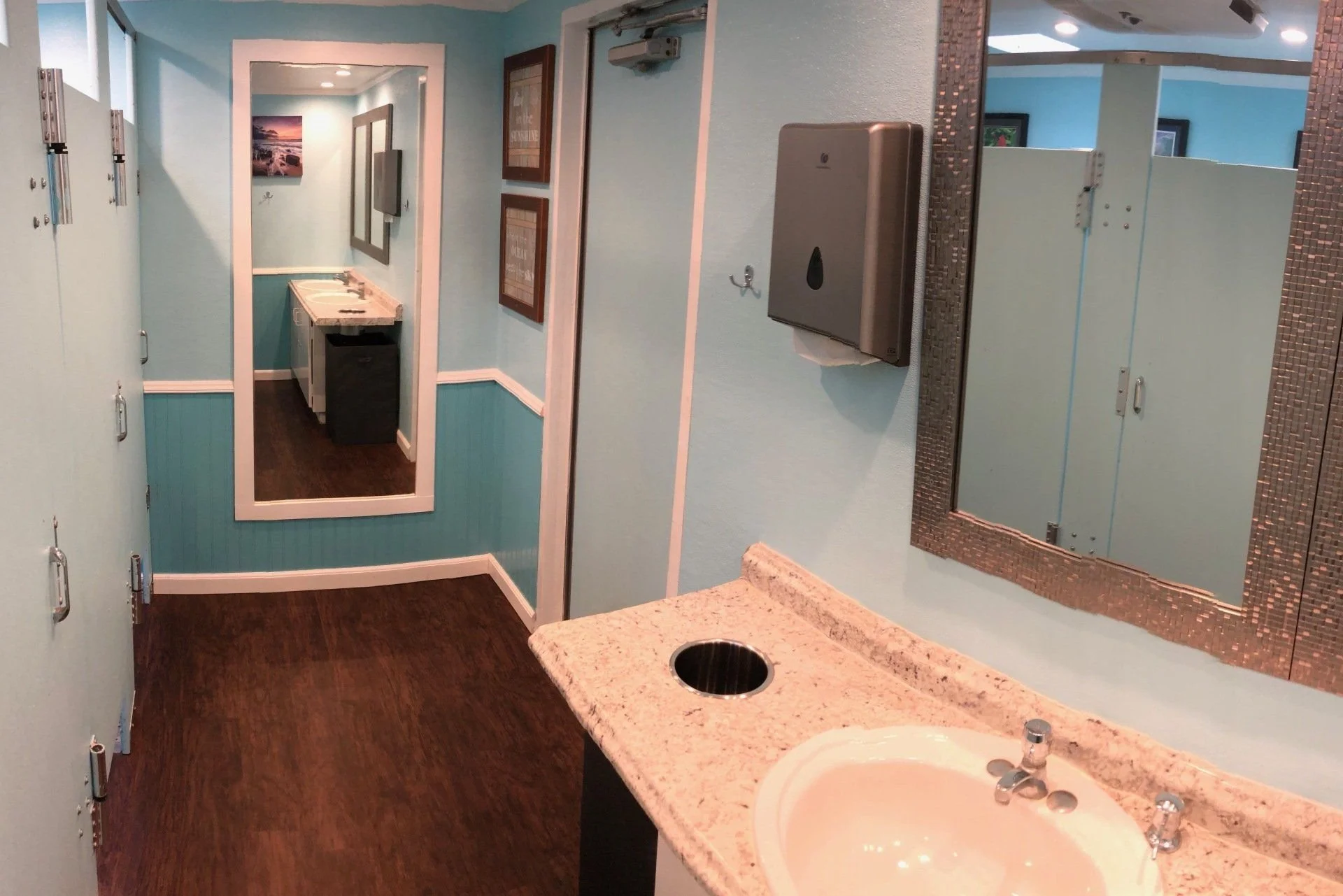 Vanity sink and mirror in an event restroom trailer.